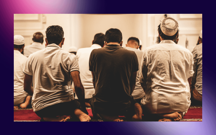 Rear view of Muslim men sitting in rows during Jummah prayer, capturing the communal essence and devotion in the act of worship.