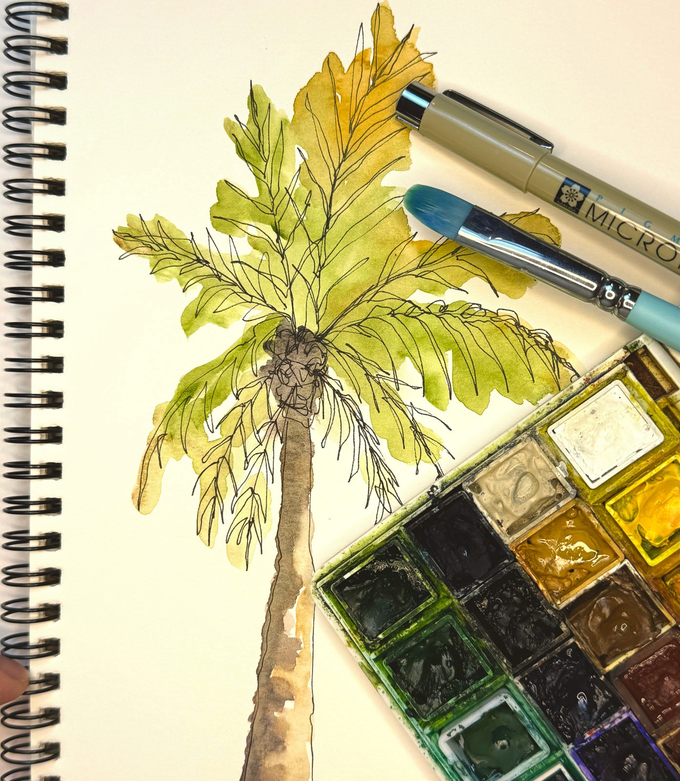 person holding green glass bottle