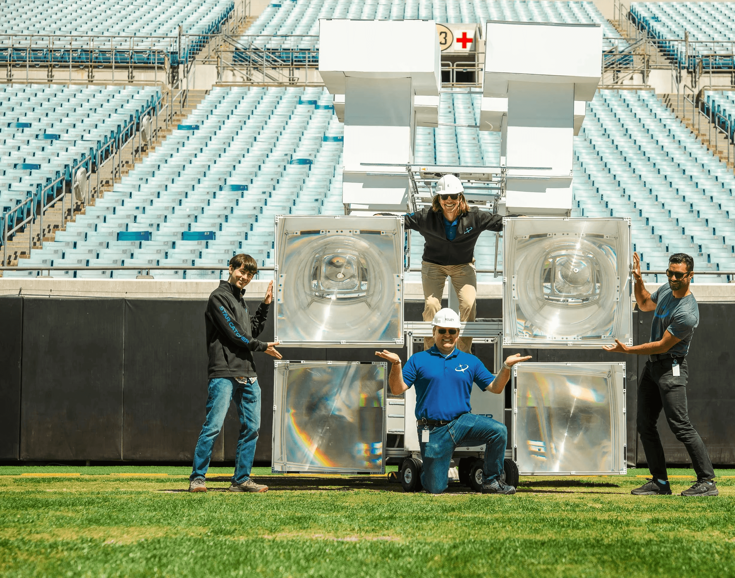Star Catcher optics team with fresnel lens hardware at EverBank Stadium after successful first public demo