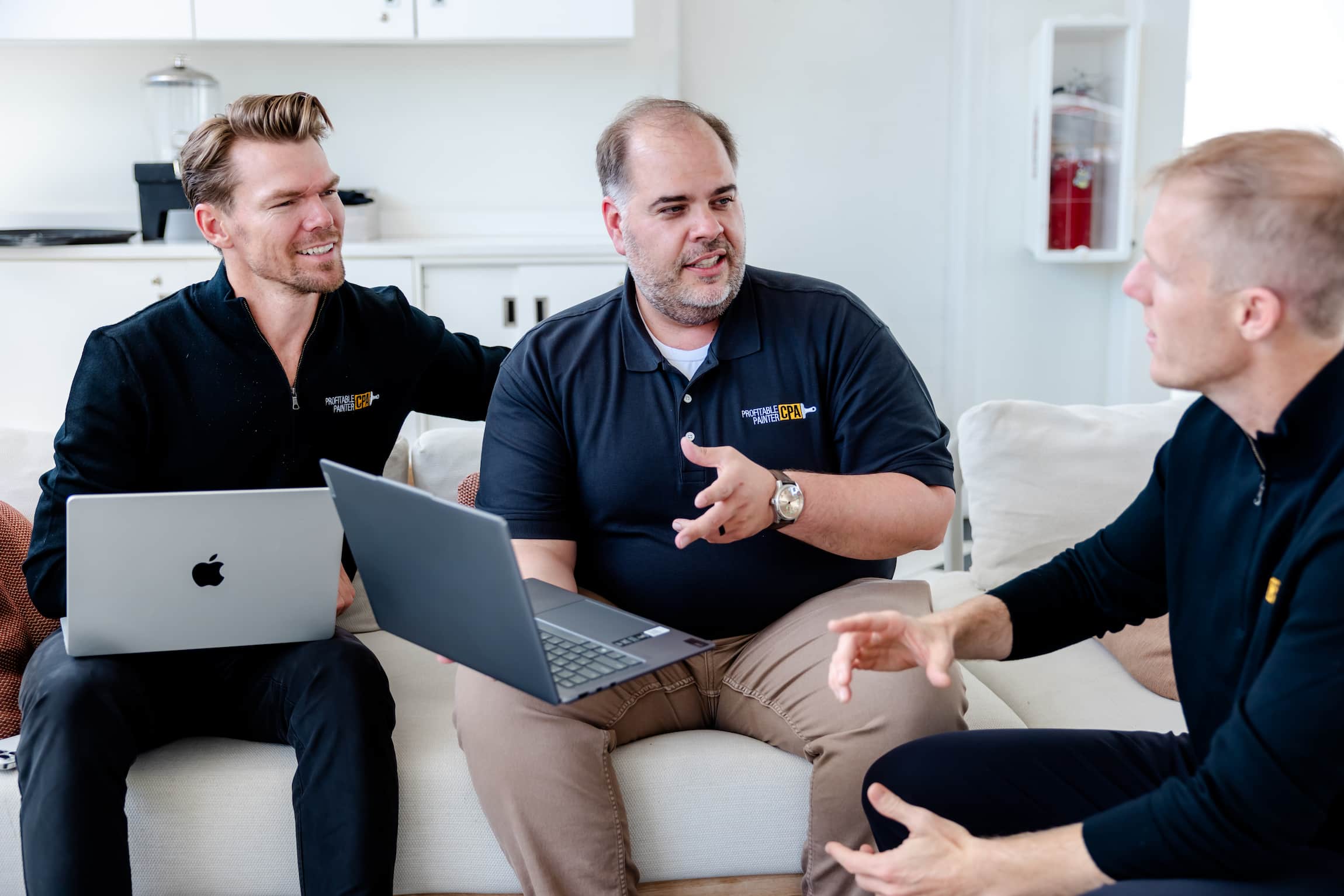 Image of Profitable Painter staff talking next to computer.