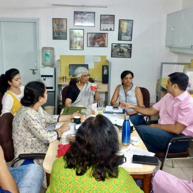 Close-up of a tree stump showing growth rings and a textured brown wood surface.