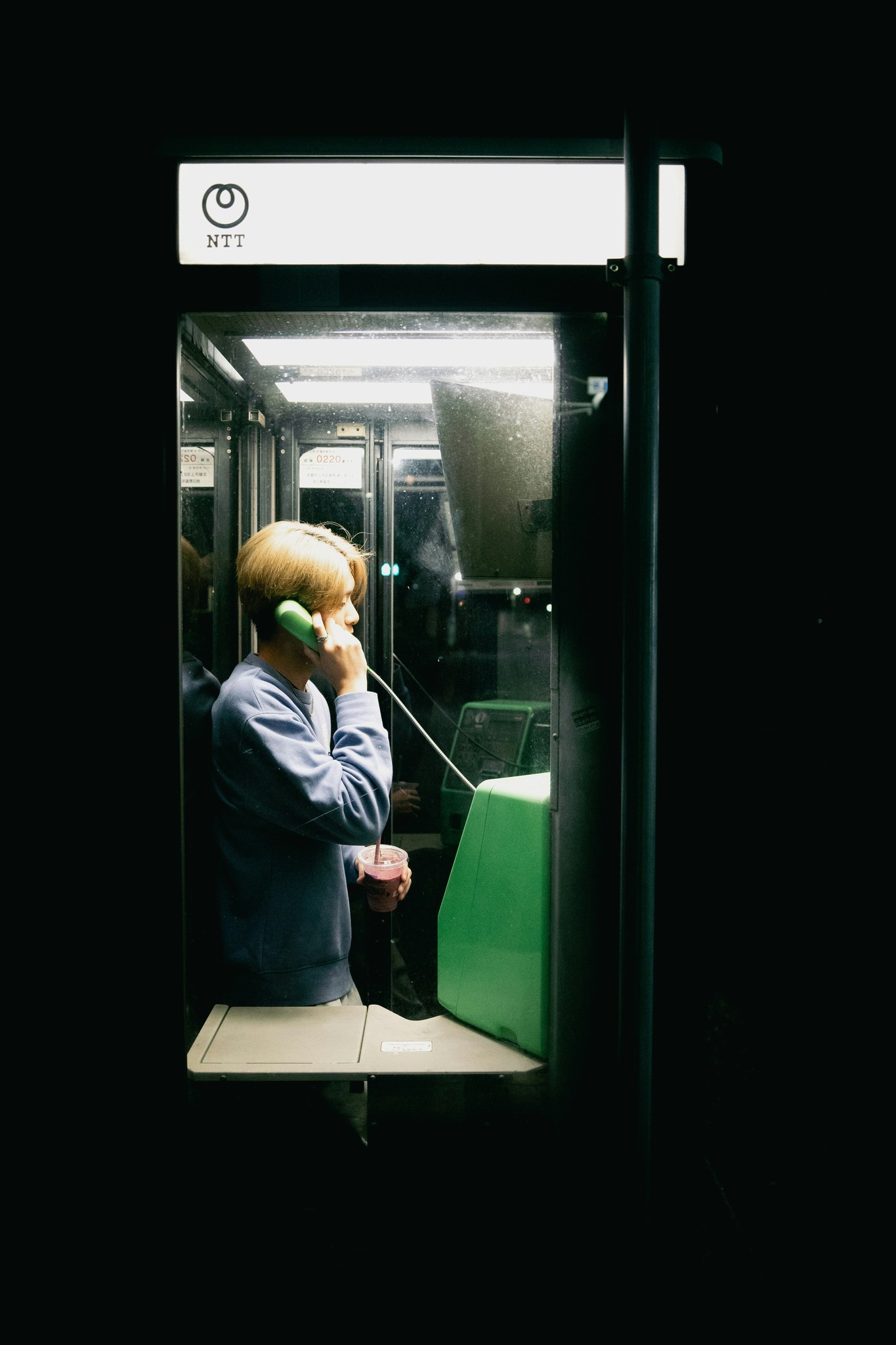 Man using phone in booth