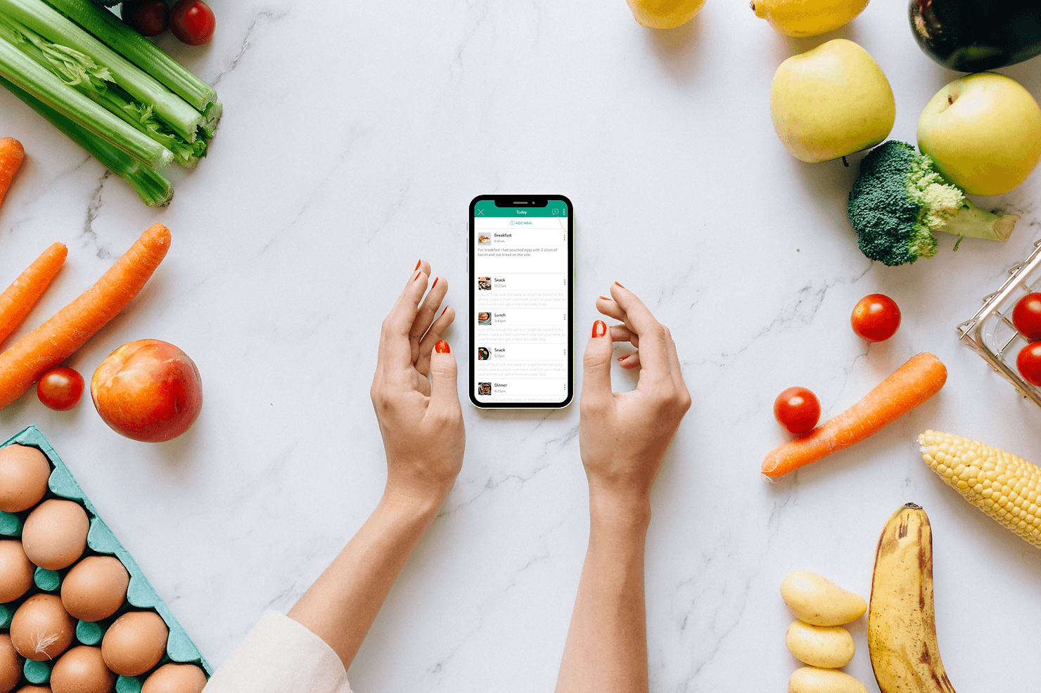 Nutrition coaching tracking on a mobile phone surrounded by various food items