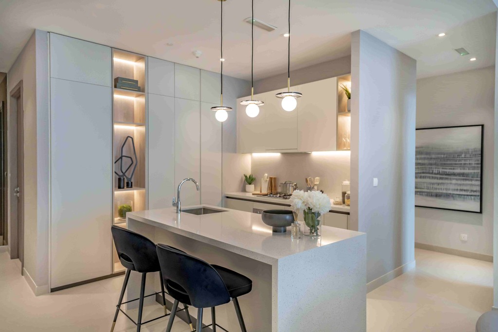 Stylish kitchen with a bar and sink, showcasing modern design at Liv Lux, Dubai.