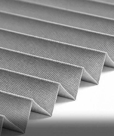 Two people sit across a table in a stylish room with red velvet walls and a large red pendant light. The mood is intimate and modern.