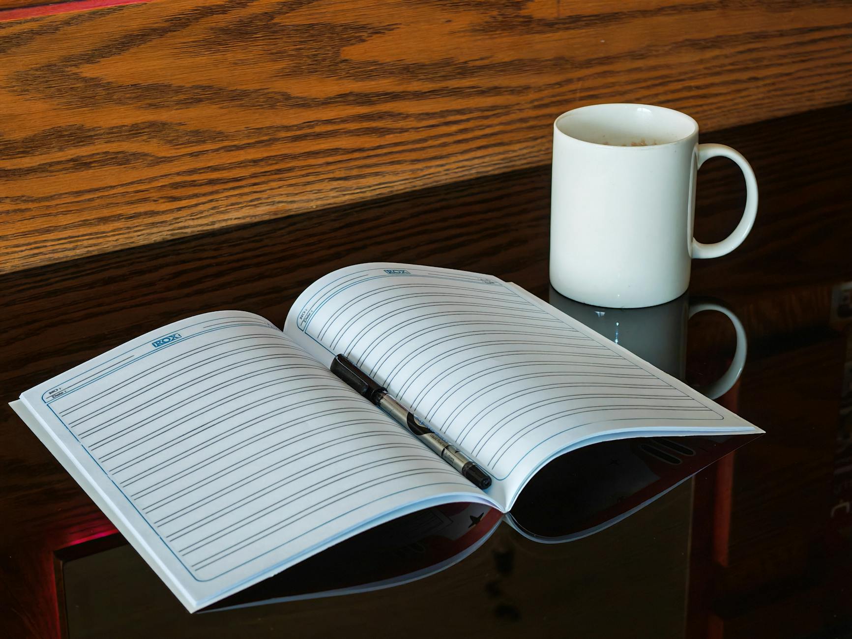 Close-up of a teacher's hands highlighting key points in a lesson plan with a yellow marker and sticky notes.