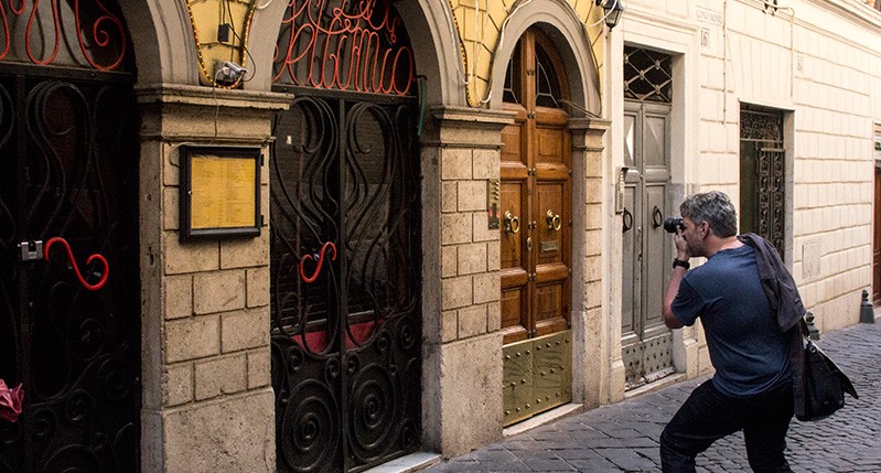 men photographing door