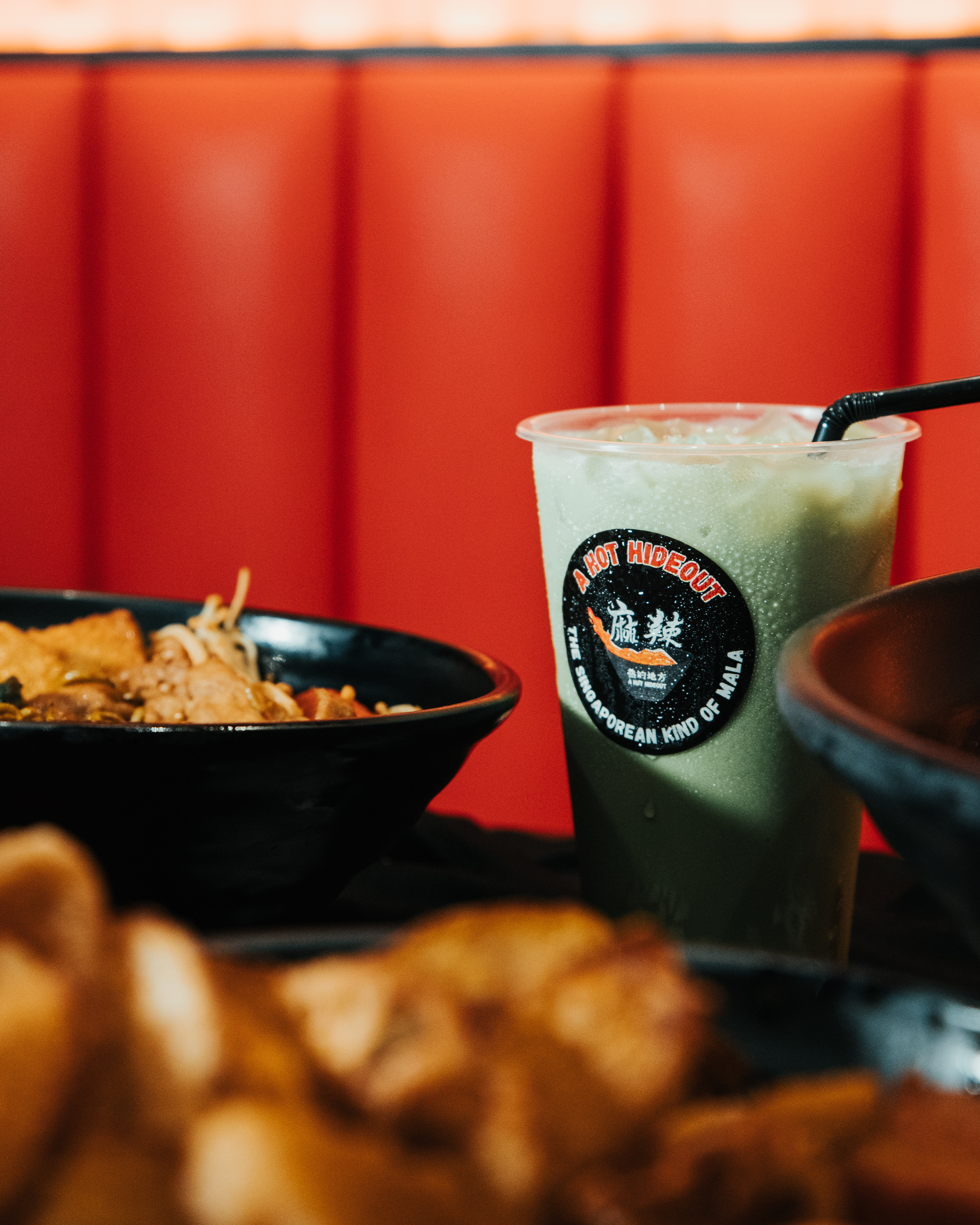 Branding photography for Hot Hideout Singapore, showcasing signature dishes and green milk tea.