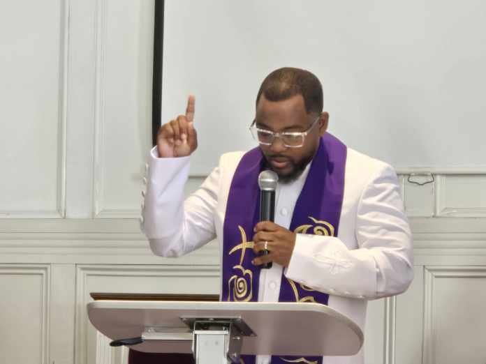 A priest holding a opened bible