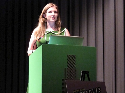 a student giving a speech from the green stand in the amphitheater