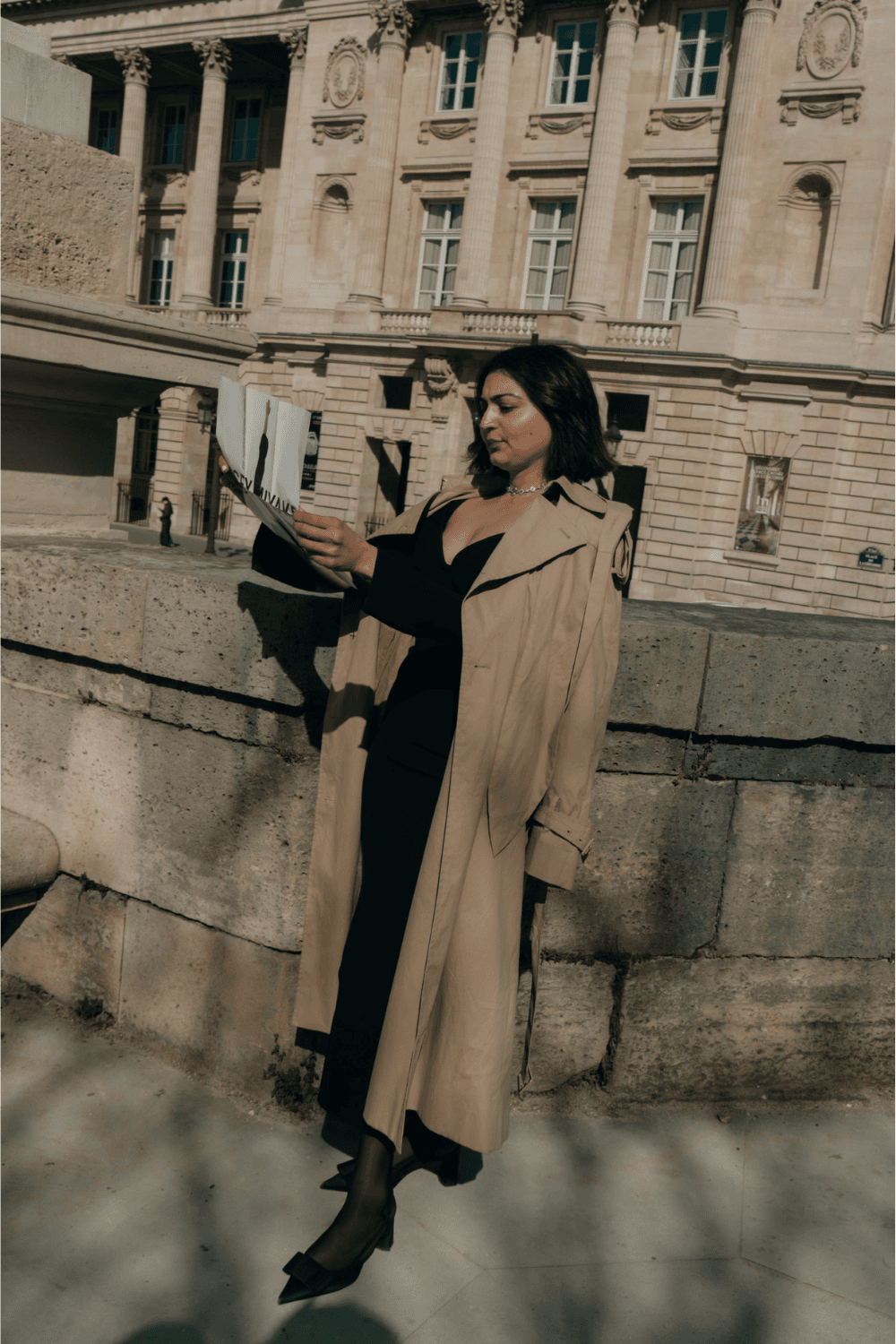 A hand in a leather jacket is inserting a cassette into a vintage boombox on a wooden shelf, evoking nostalgia and retro vibes.