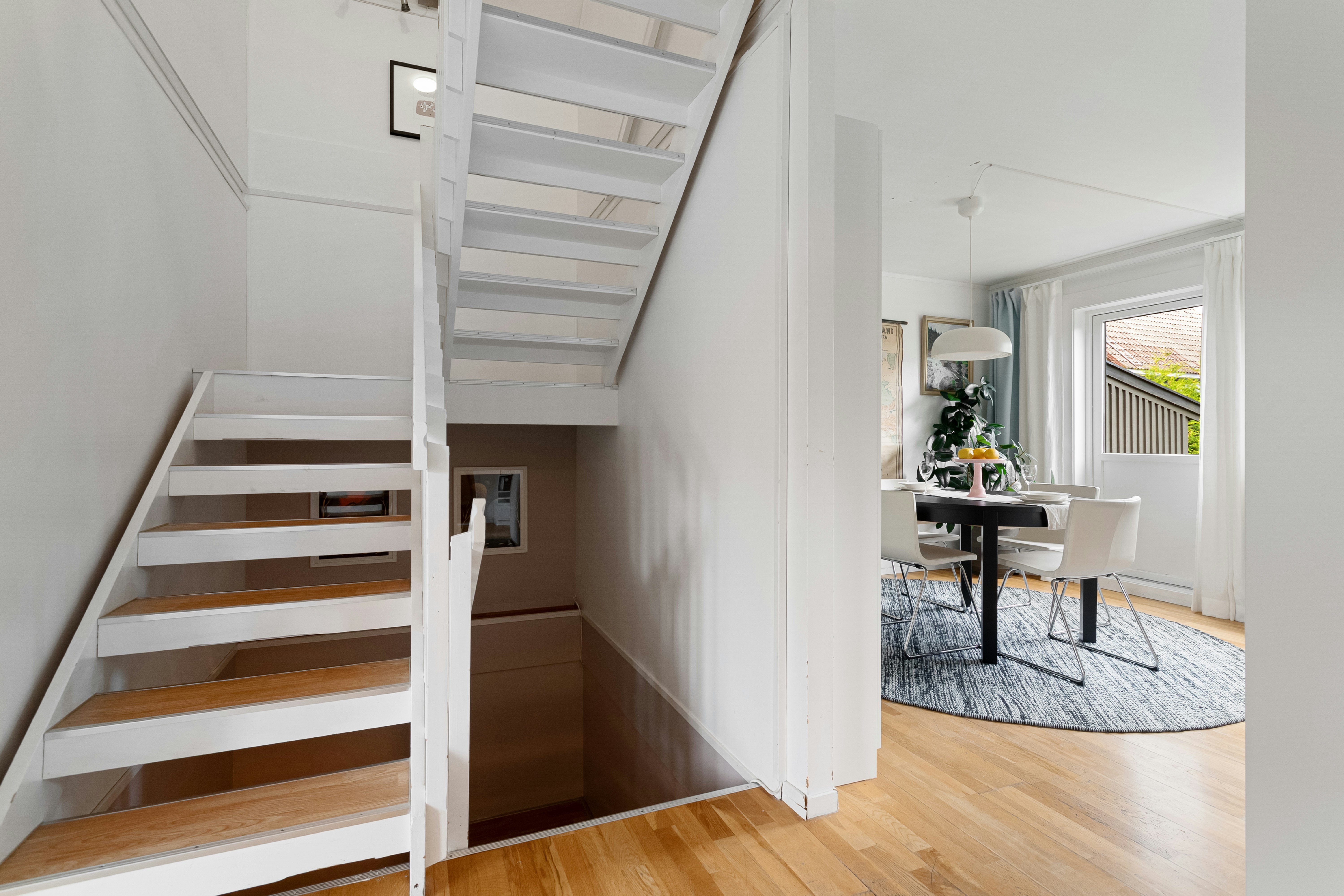 A staircase leading up to a dining room table
