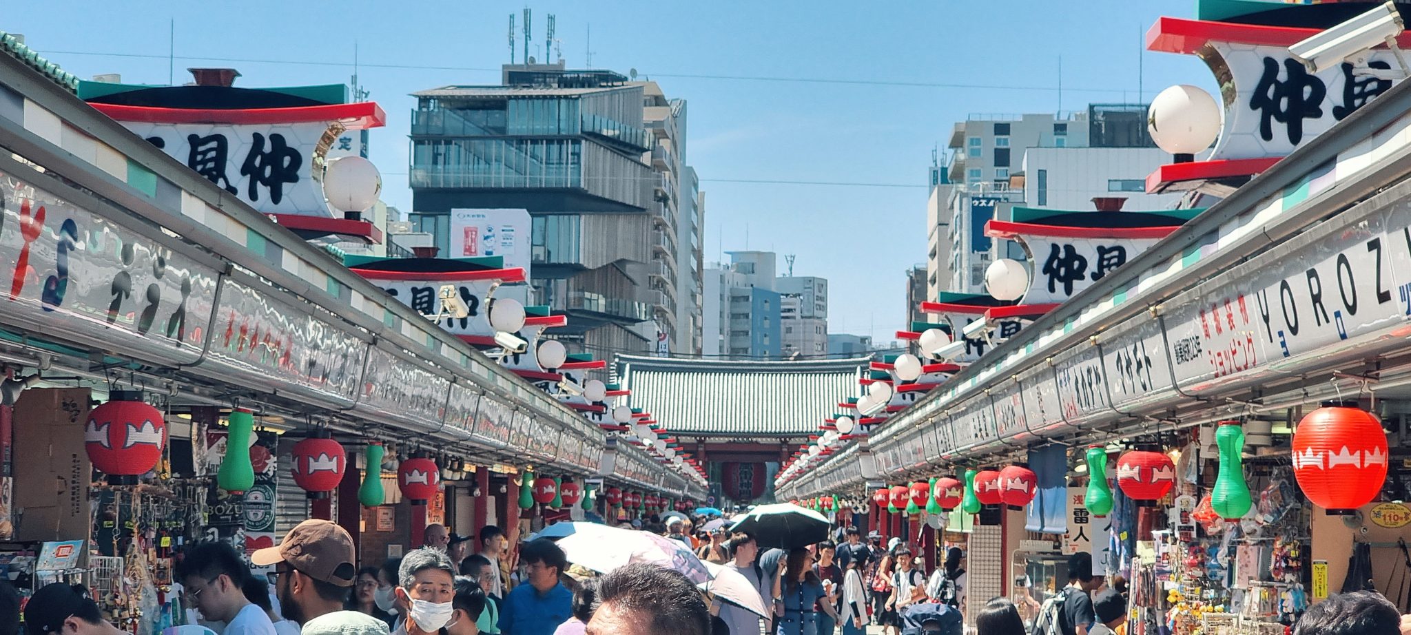 Nakamise shopping street lined with lantern signage leading to Sensoji Temple's gate