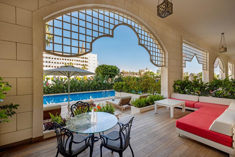 Terrace with sun loungers offering a relaxed space just steps from the pool.
