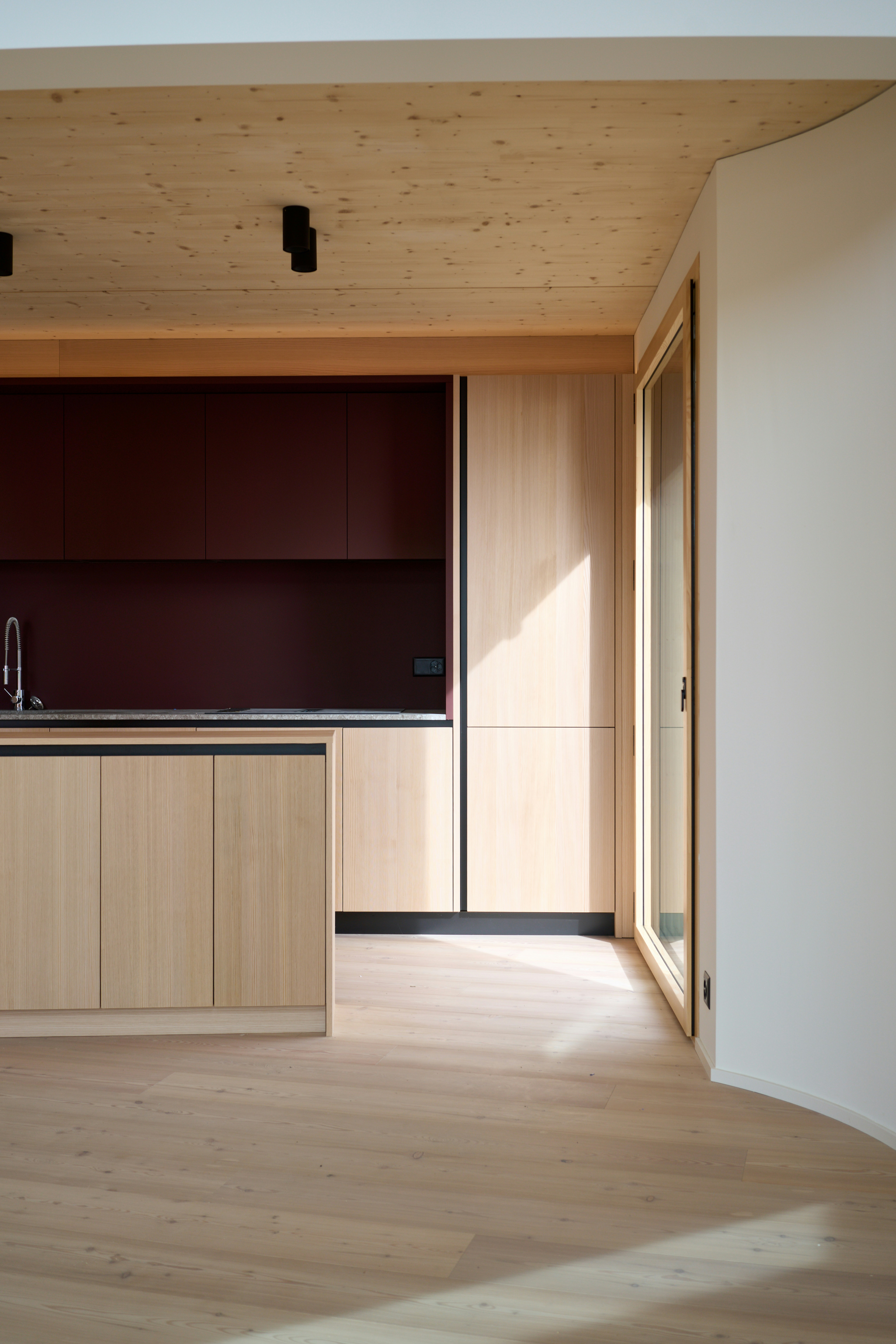 A kitchen with a wooden floor and cabinets