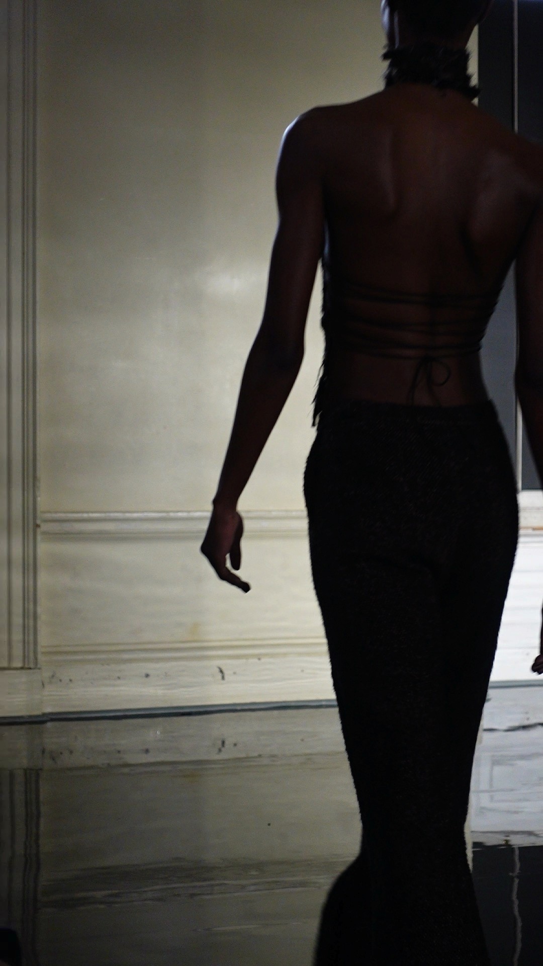 Silhouette of a model at a fashion event.