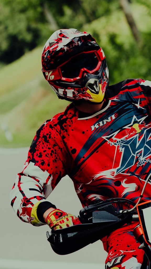 Close-up of a motorcyclist looking at the camera in a natural setting