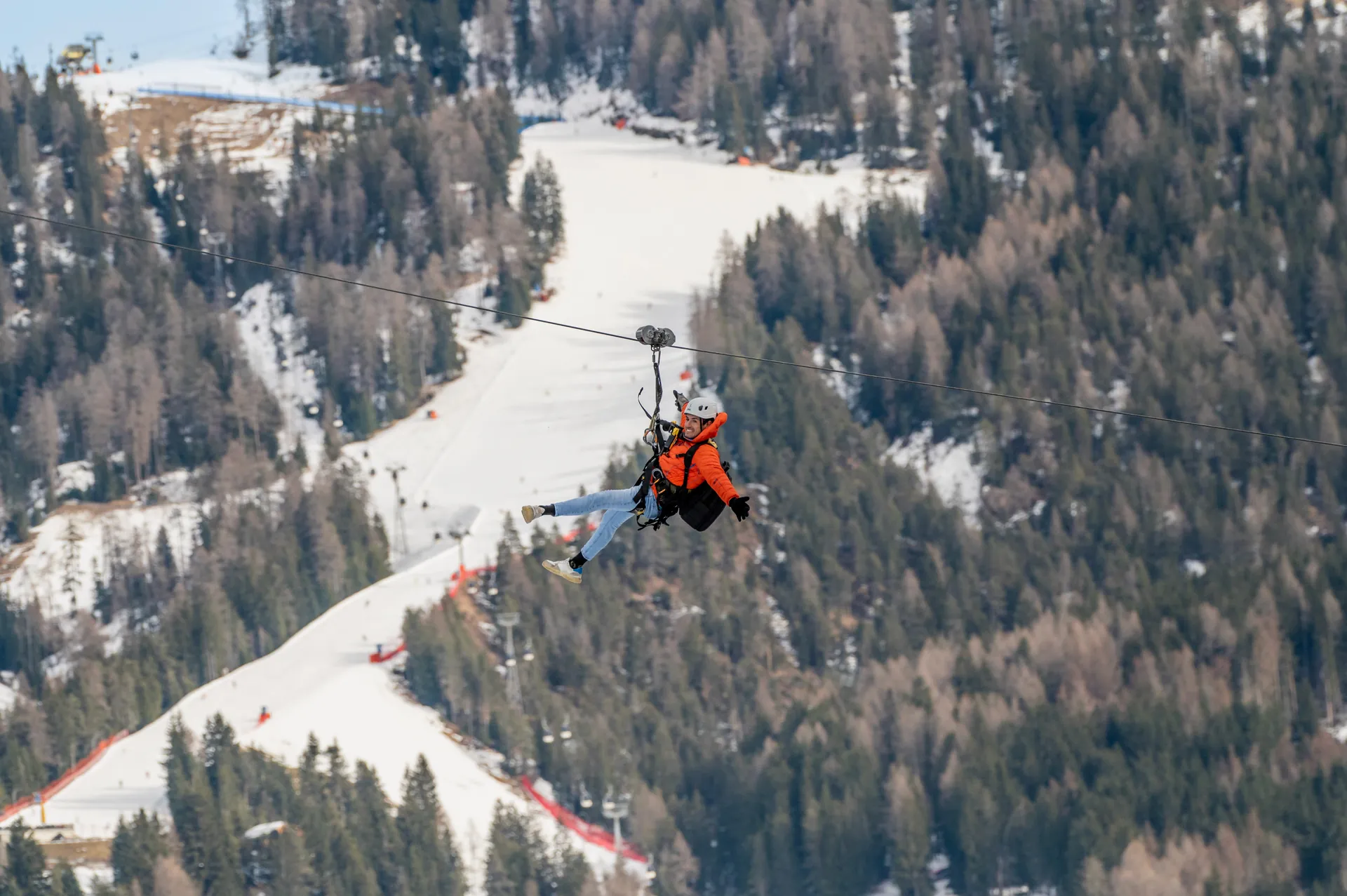Winter zipline above the snow-covered ski slopes