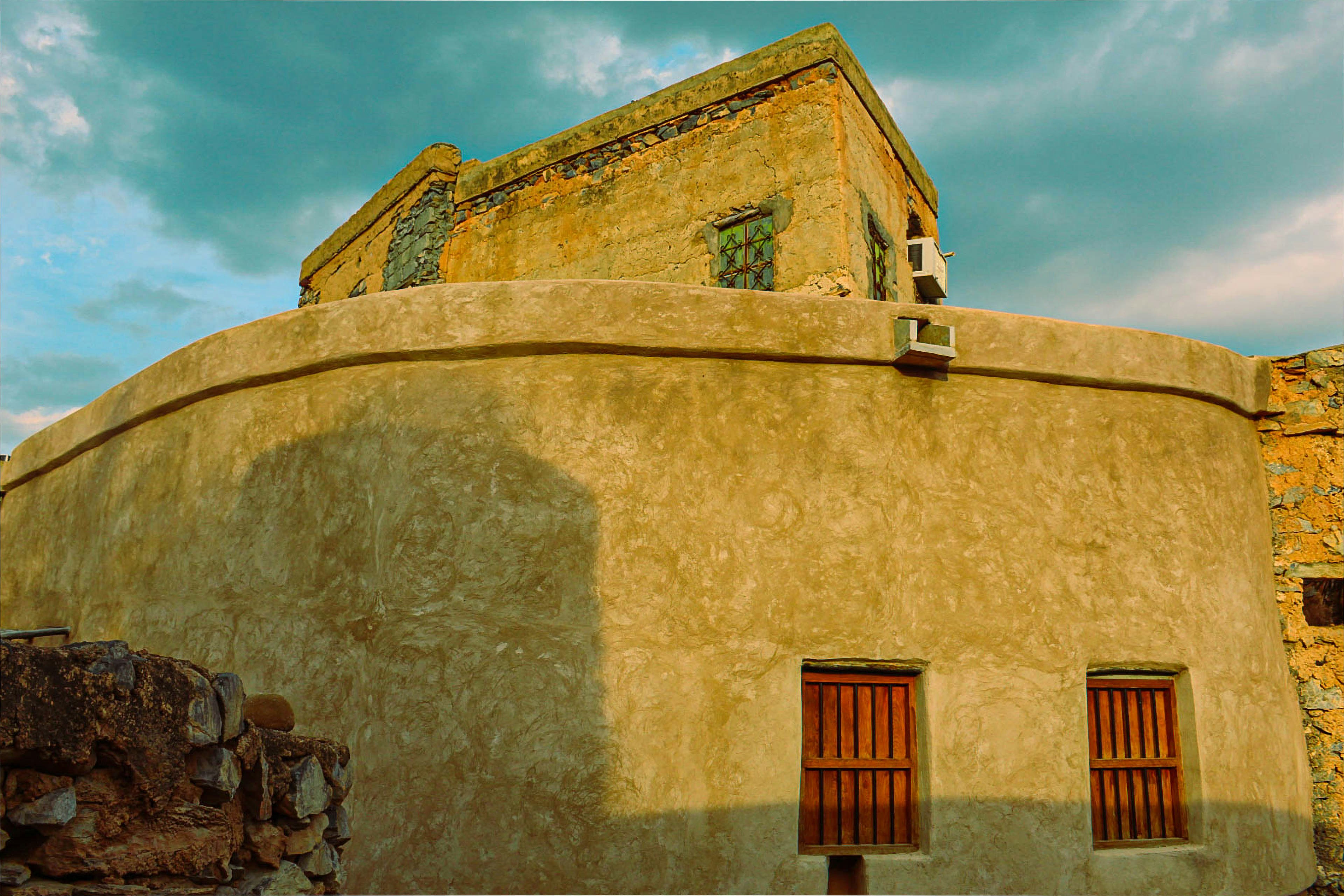 an old building with two doors and a window