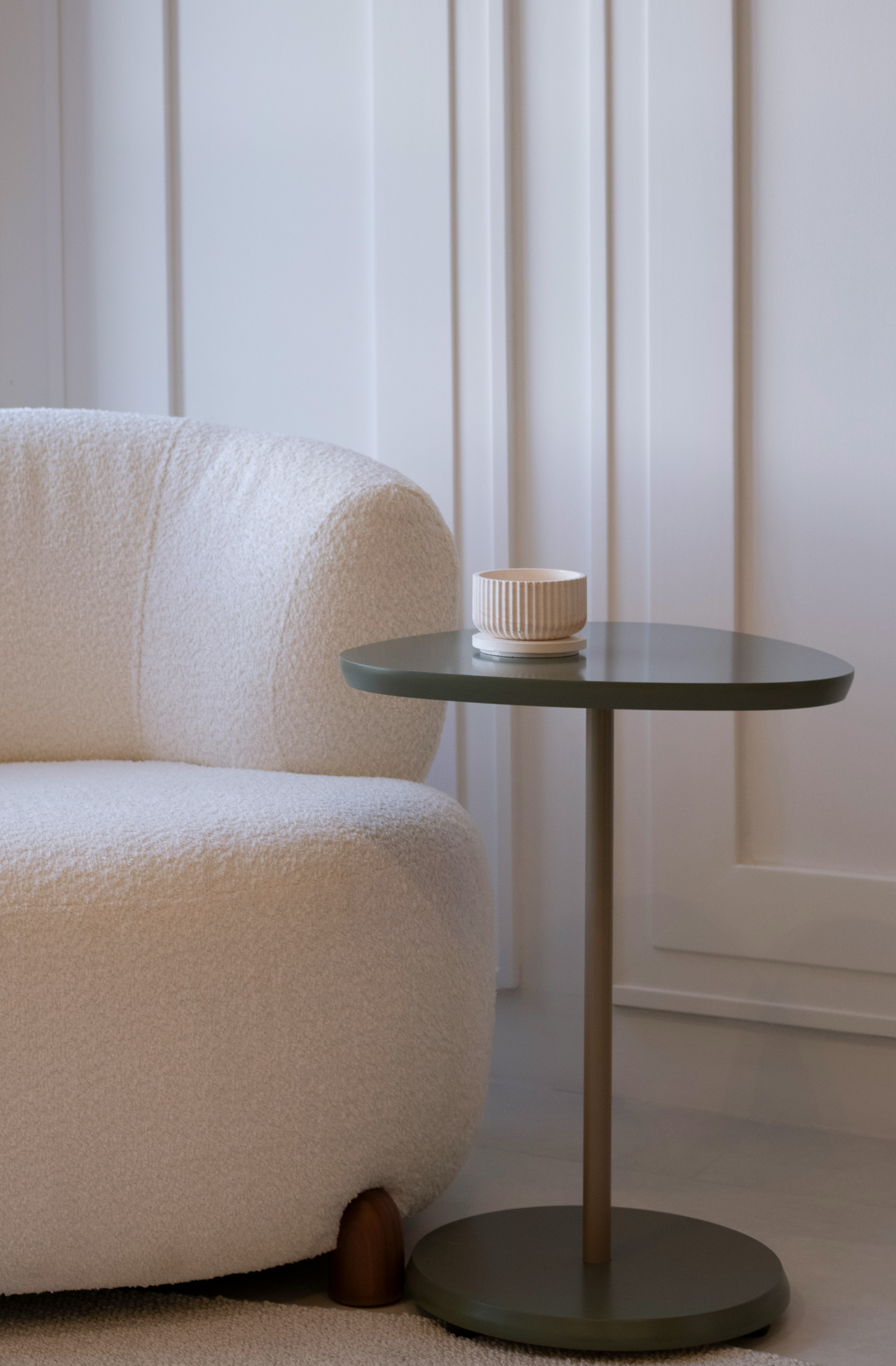 A cozy armchair next to a small side table.