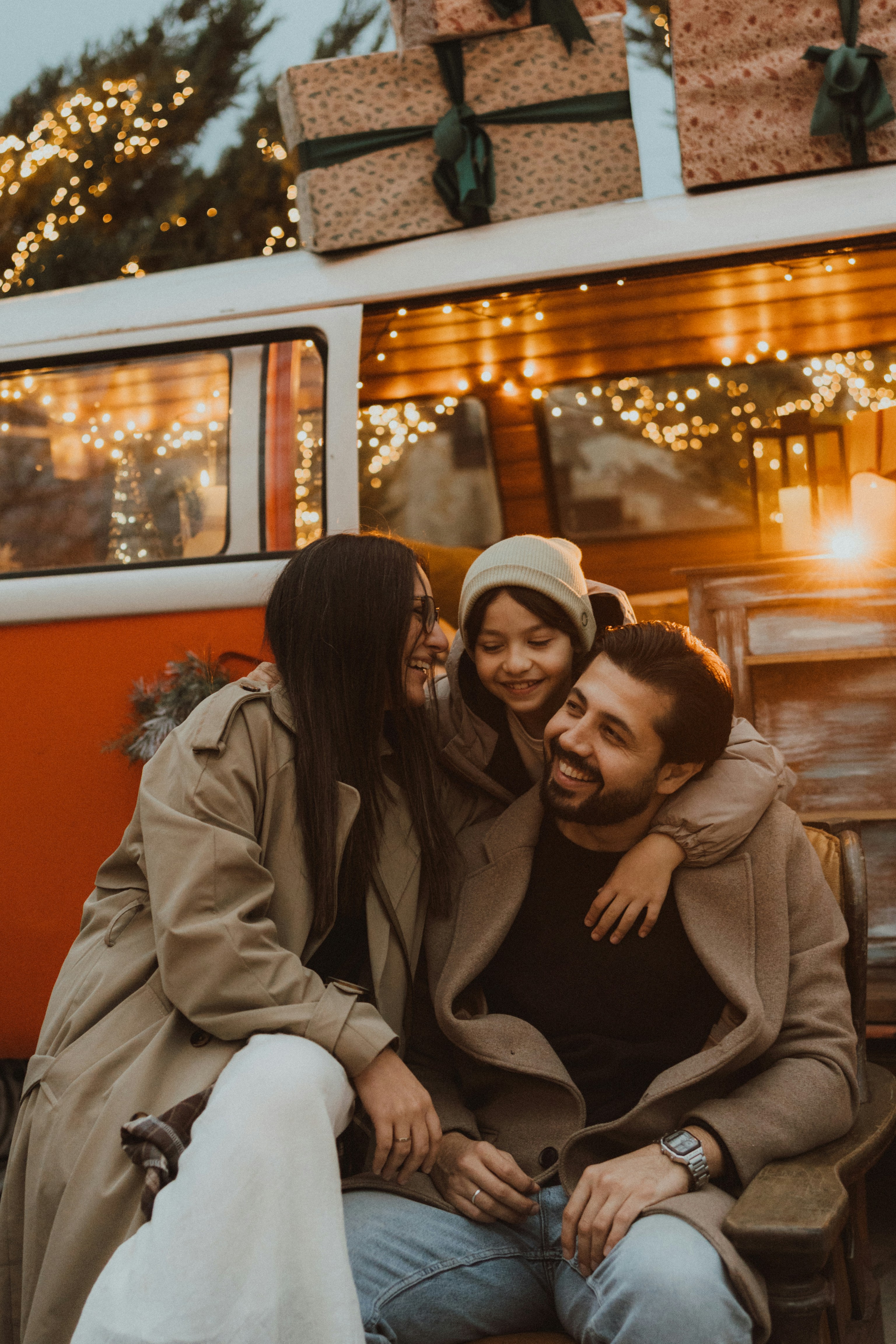 Family smiles in front of a decorated van