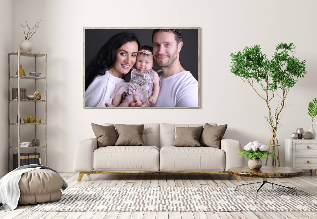 A warm and happy family photoshoot frame hangs on the wall, captured in a creative family photography in Dubai by Mahvin.