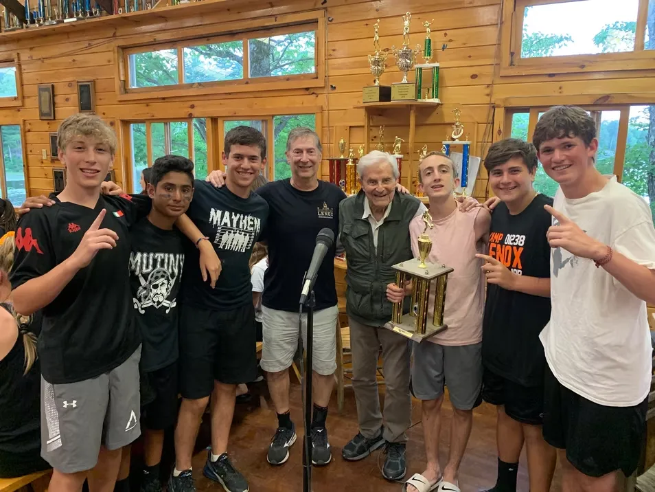 Rich Moss with the Camp Lenox basketball team holding a trophy