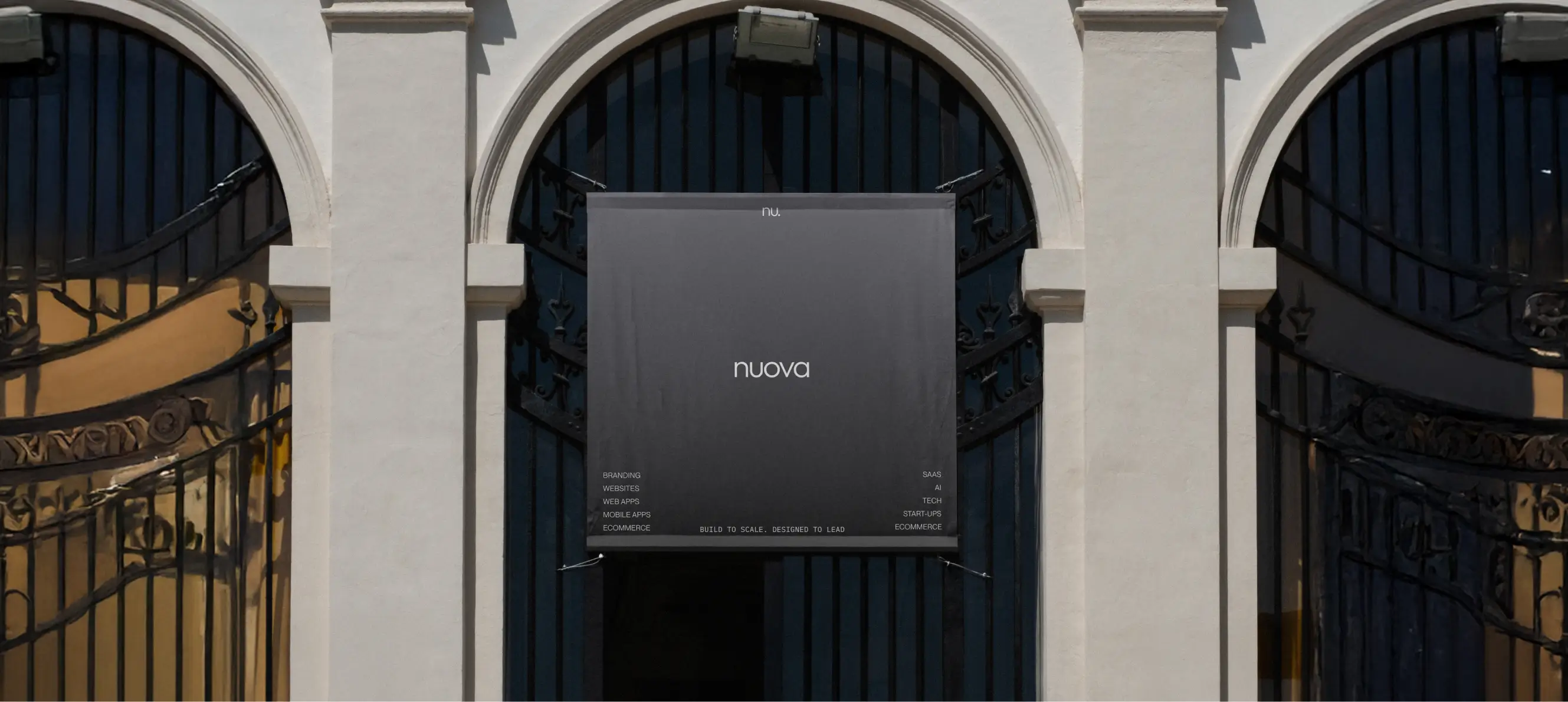 A tall building with columns and a bilboard in the center