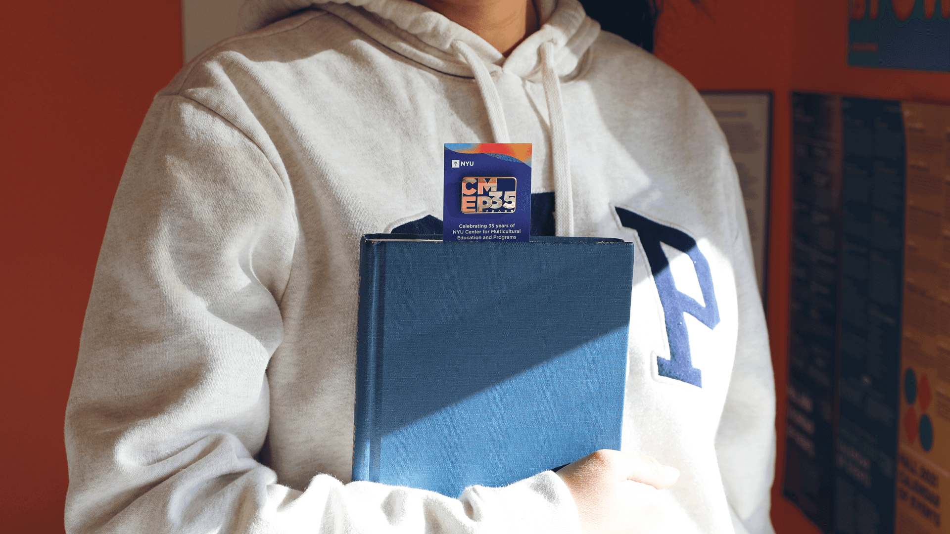 Person holding a Book with a CMEP 35th Bookmark