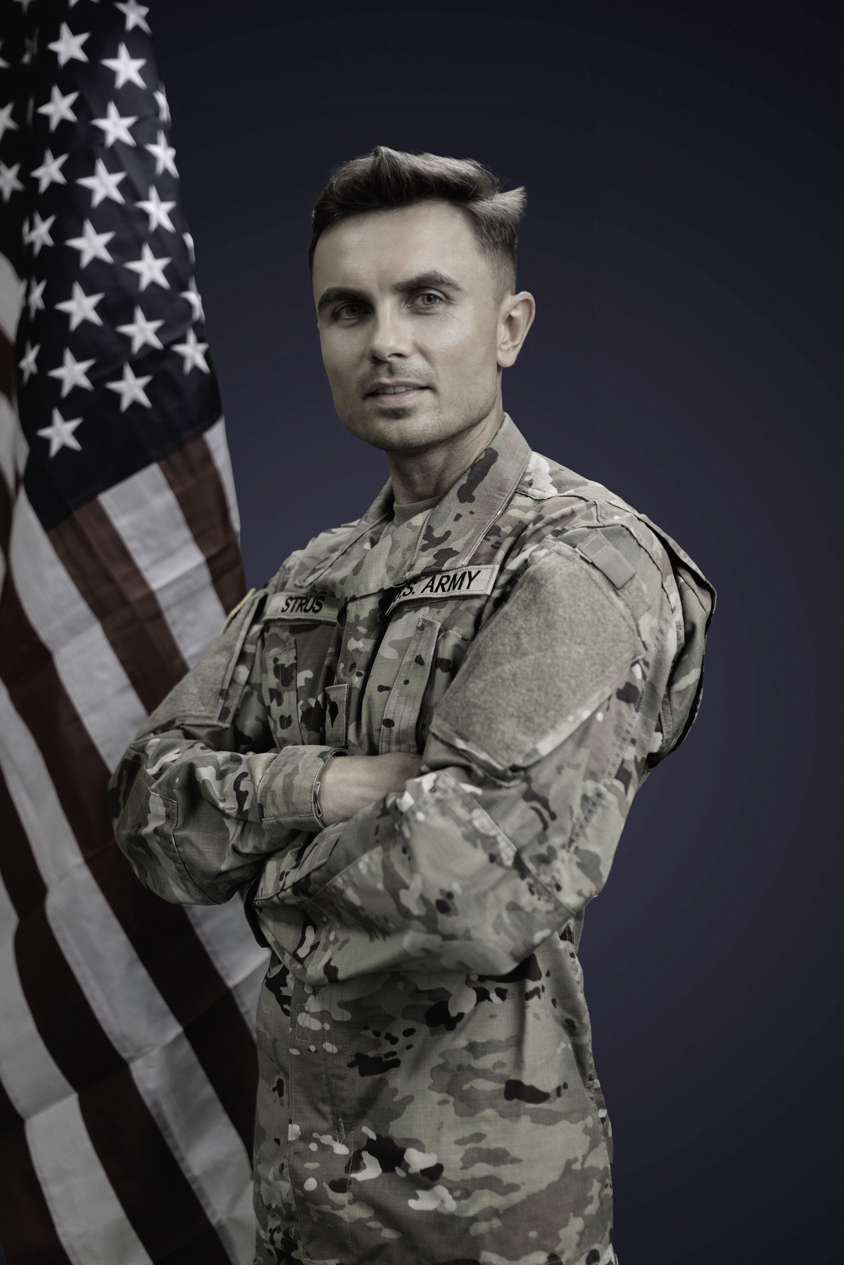Dylan Strus in US Army uniform with the American flag — veteran-owned Atlanta wedding photographer