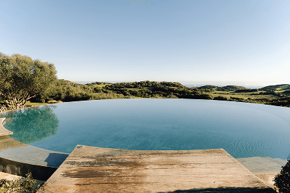 two lounge chairs near swimming pool