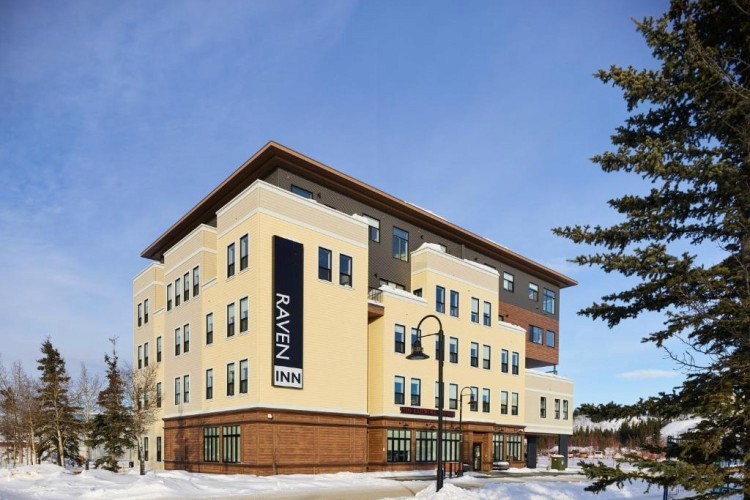 sunloungers fronting buildings near mountain