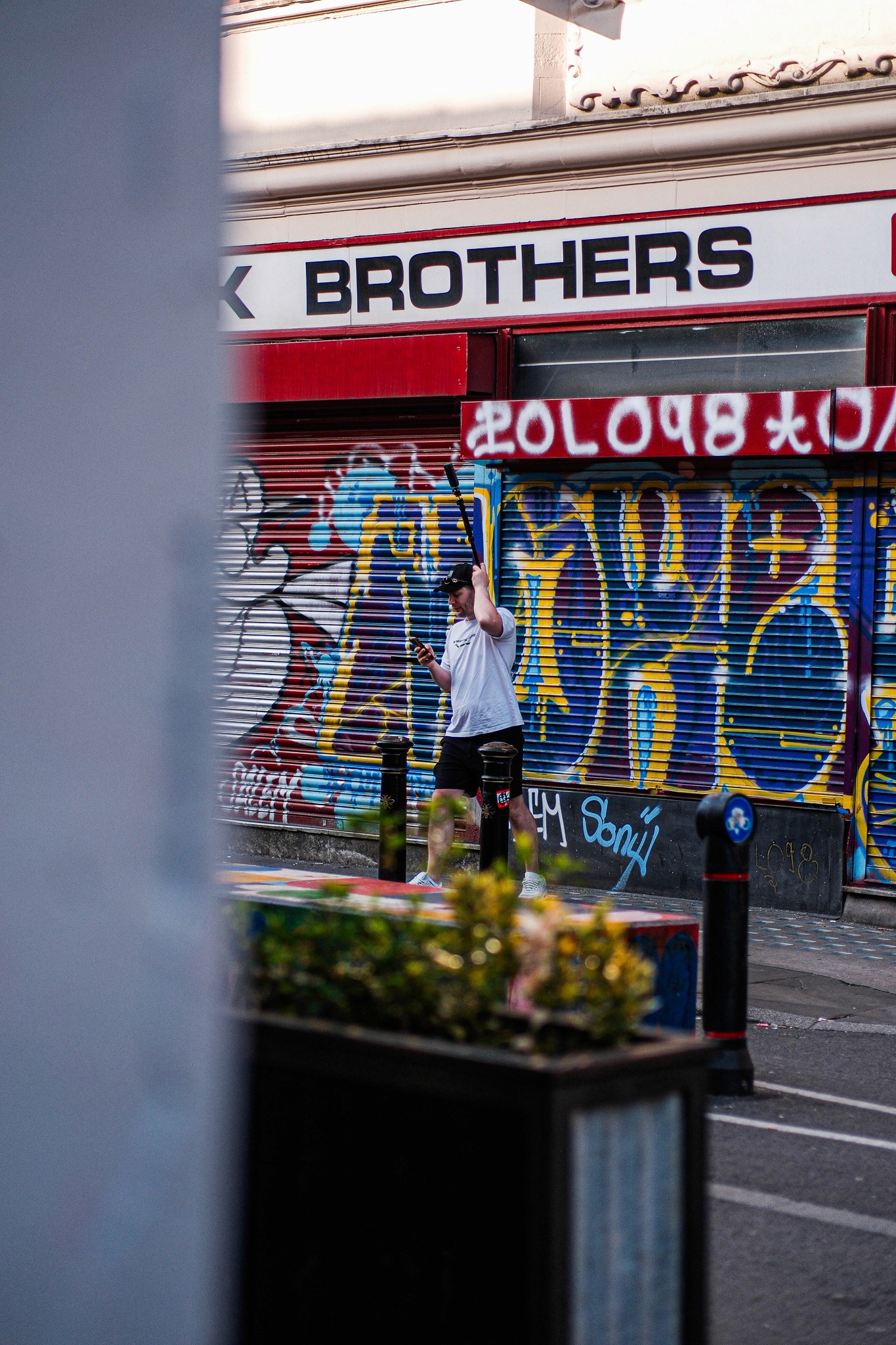 Behind-the-scenes photograph of Gabriel Trinc capturing 360 imagery on Thomas Street in Manchester's Northern Quarter for the Bound store visualisation project by James Lyons of PixelSpaces, documenting the surrounding urban environment for architectural CGI development