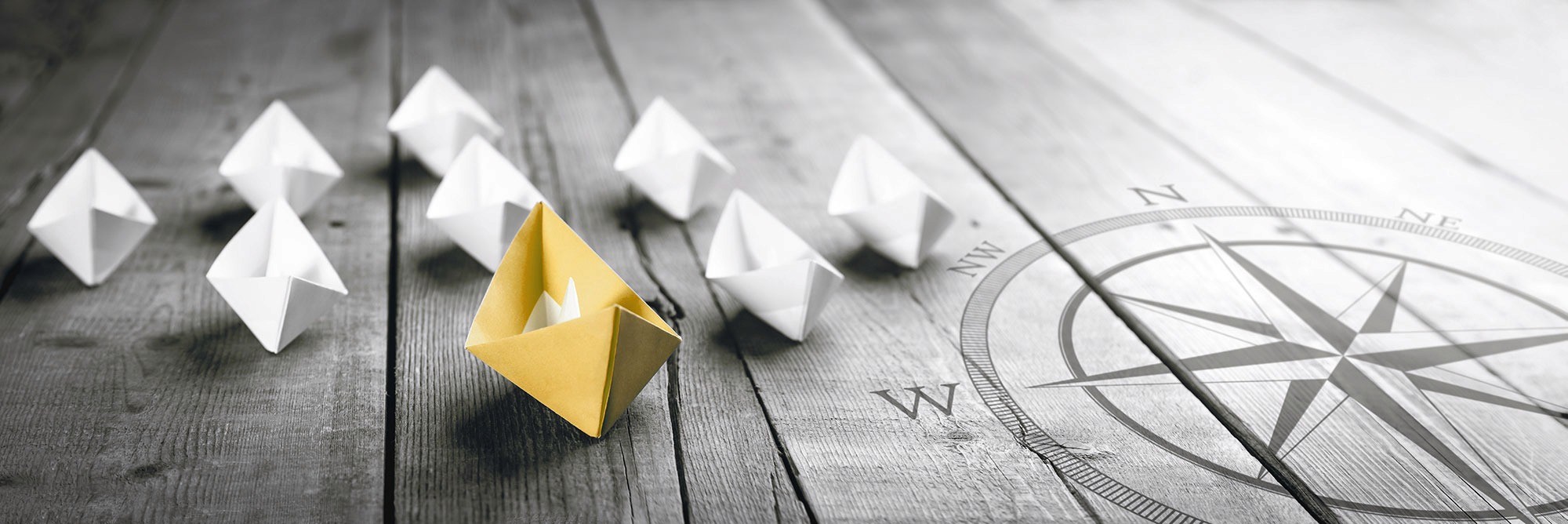 paper boats and a compass