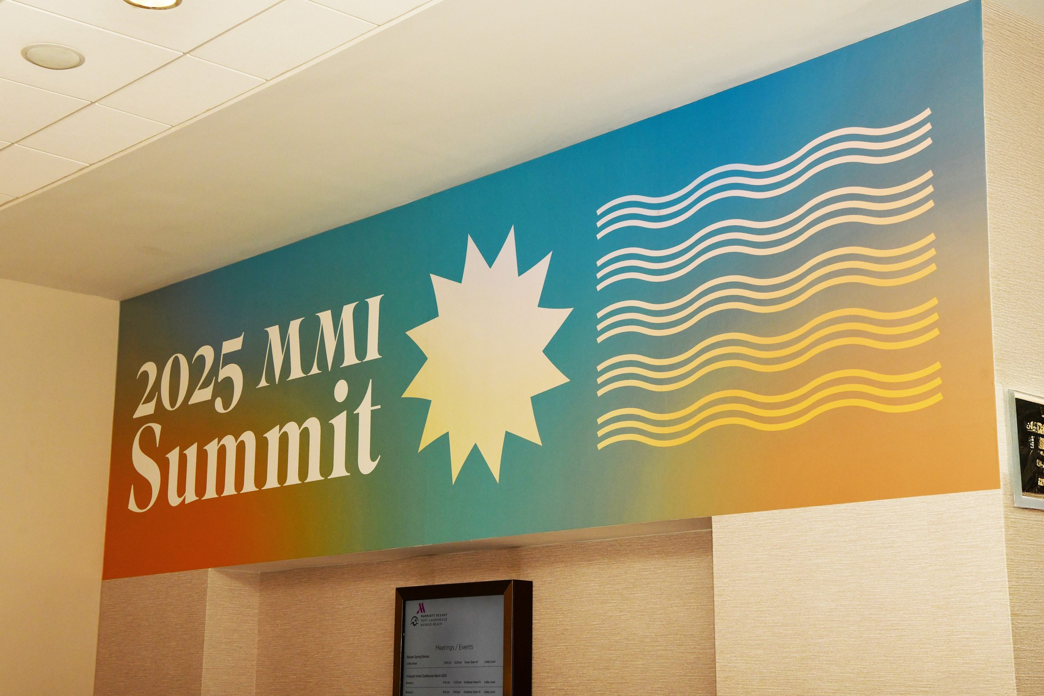 2025 MMI Summit onsite branding horizontal vinyl cling on a wall interior of hotel