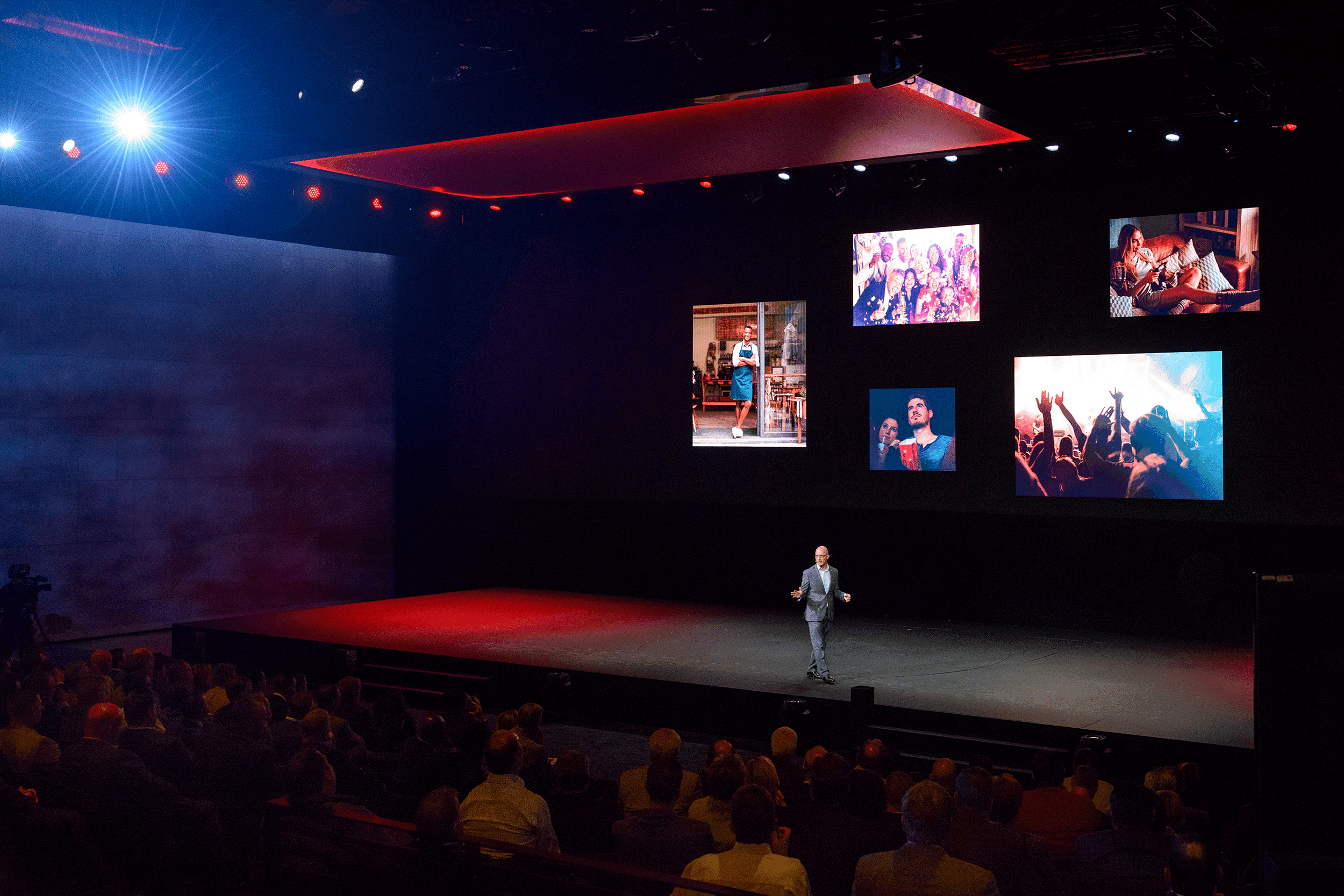 Mazda National Brand Summit executive on stage with red hue lights