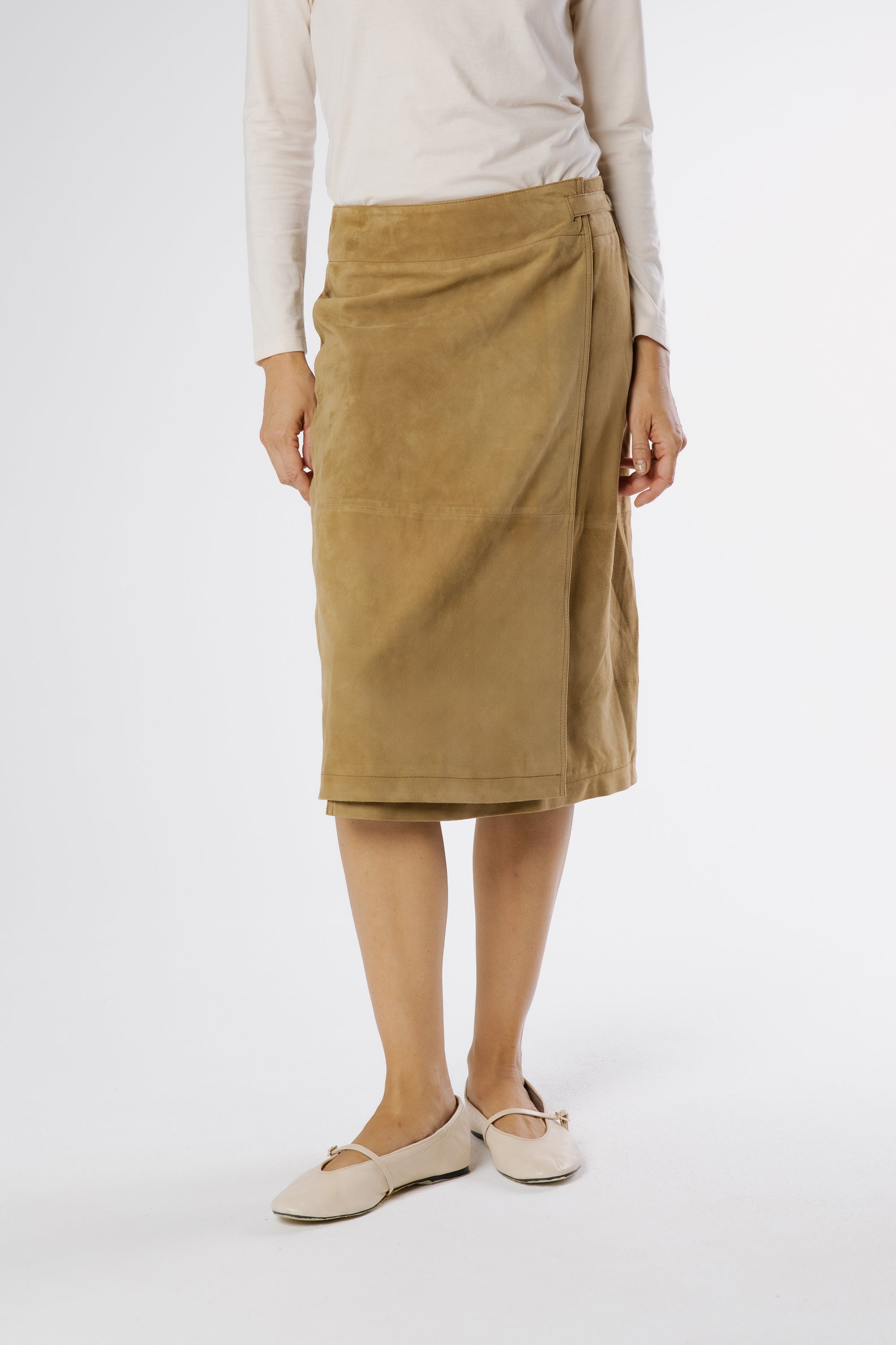 Close-up detail of Danny suede midi skirt in Olive, showing the velvety suede texture, panel construction, and clean wrap edge.