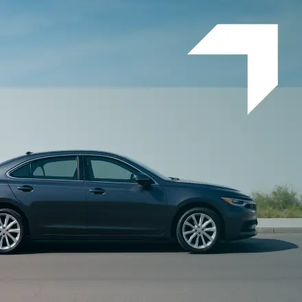 Black business sedan parked on a road under a clear sky — representing GIA Group, LLC’s business auto insurance coverage for commercial vehicles.