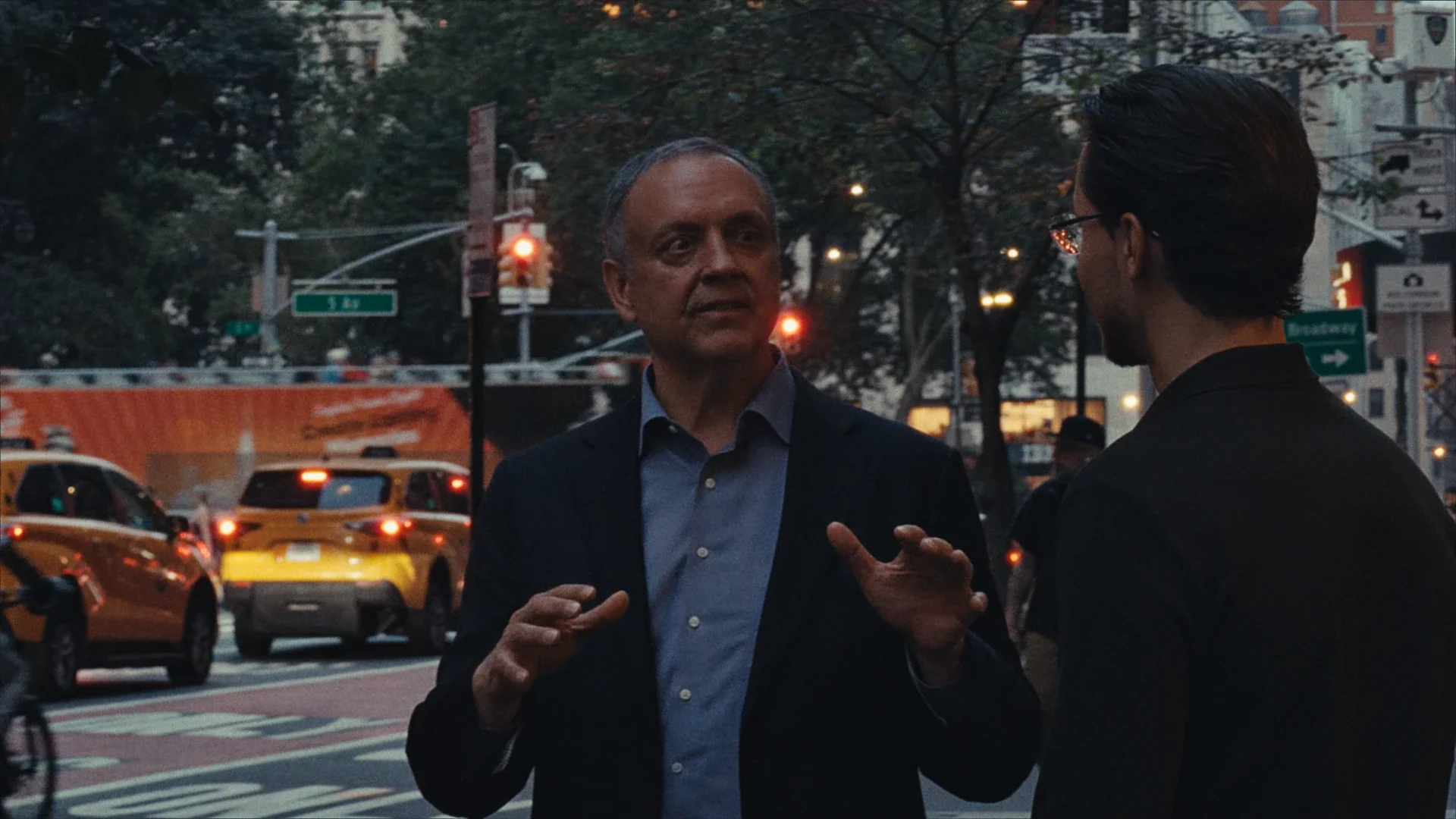 Two men talking on a New York street at dusk