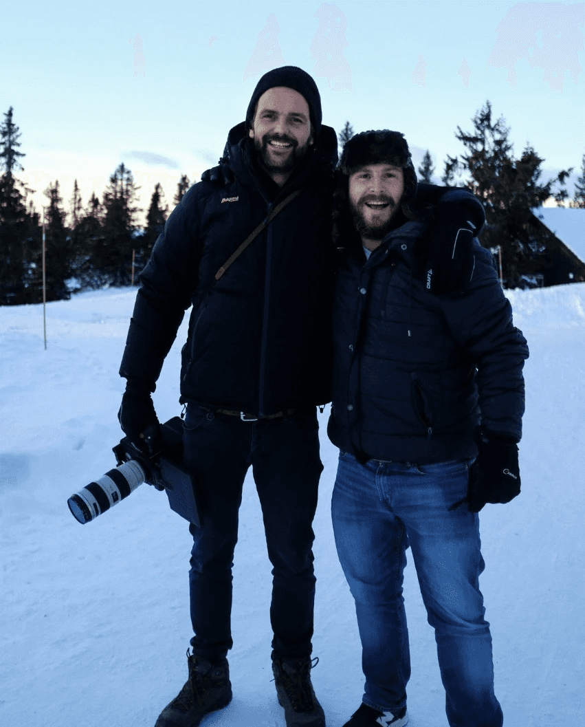 A thoughtful young person with dark hair gazes to the side, captured in soft black and white lighting.