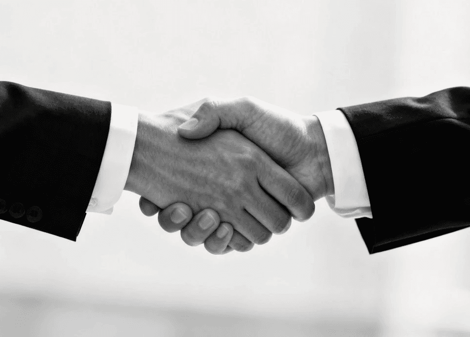 people walking on green grass field near white concrete building during daytime