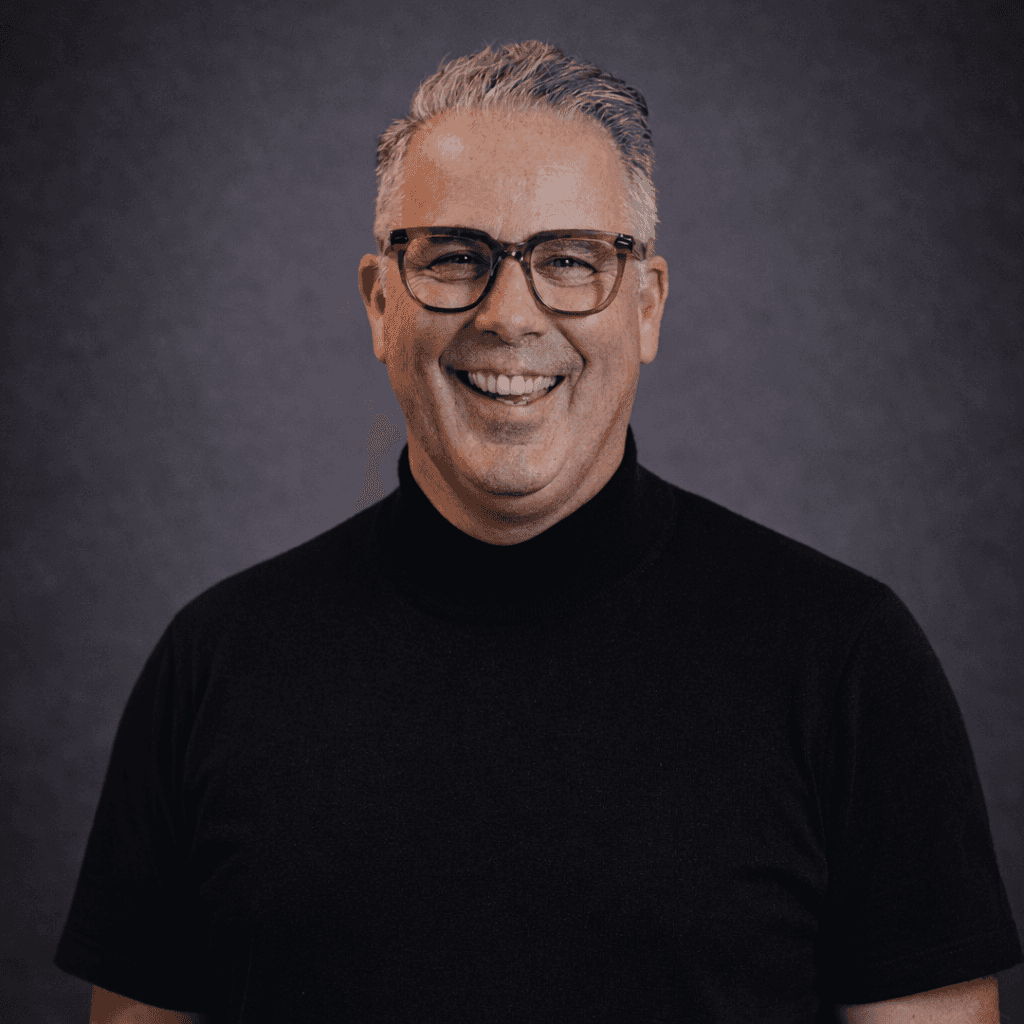 A woman with straight blonde hair wearing a light colored sweater looks away.