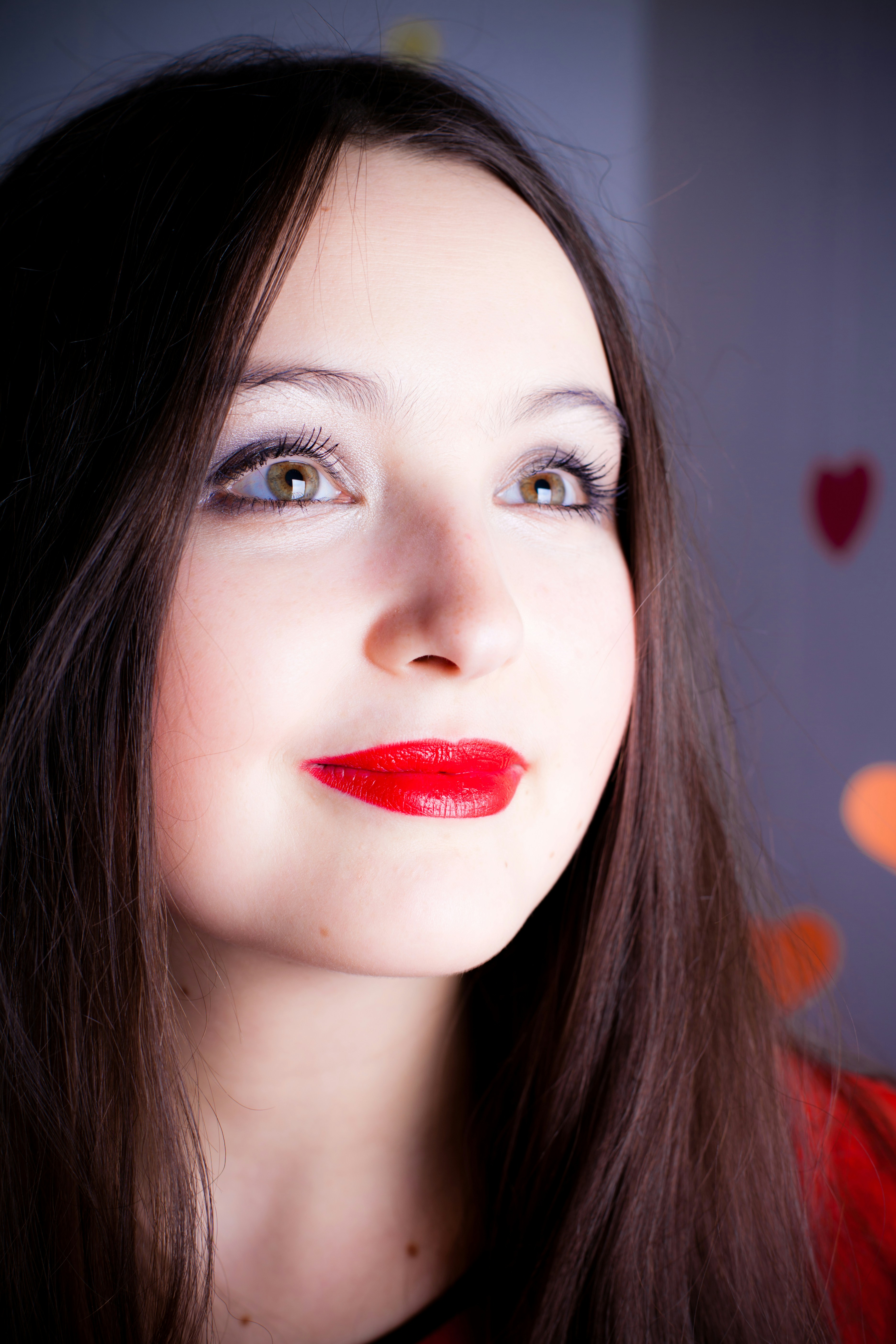 A woman with long dark hair and red lipstick