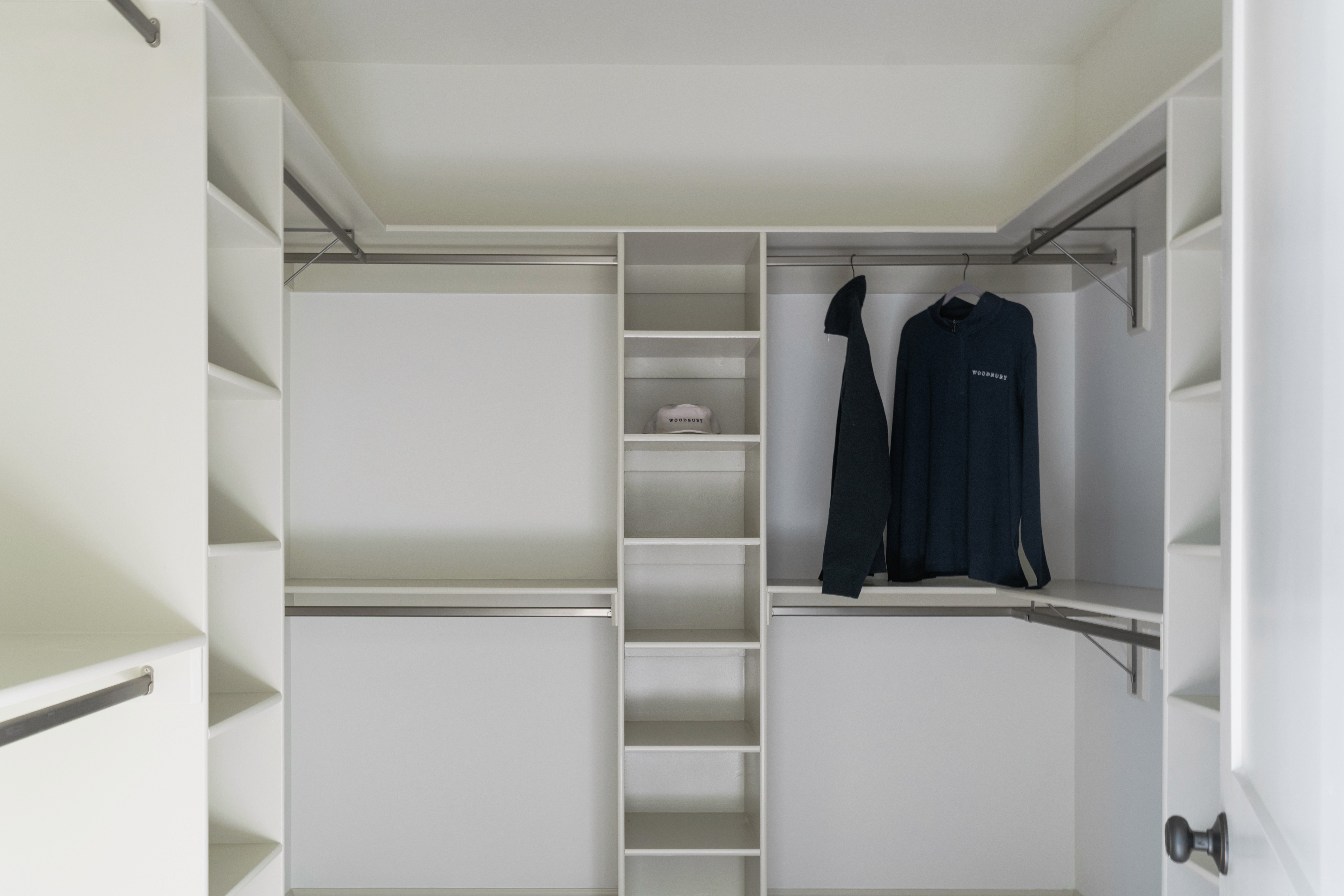 Master bedroom walk-in closet with built in shelves.