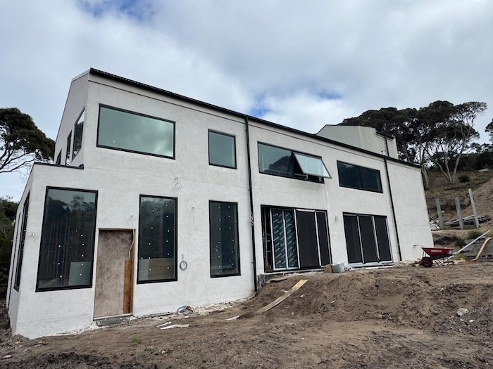 A Photo outside of the house showing a wall made in hempcrete blocks