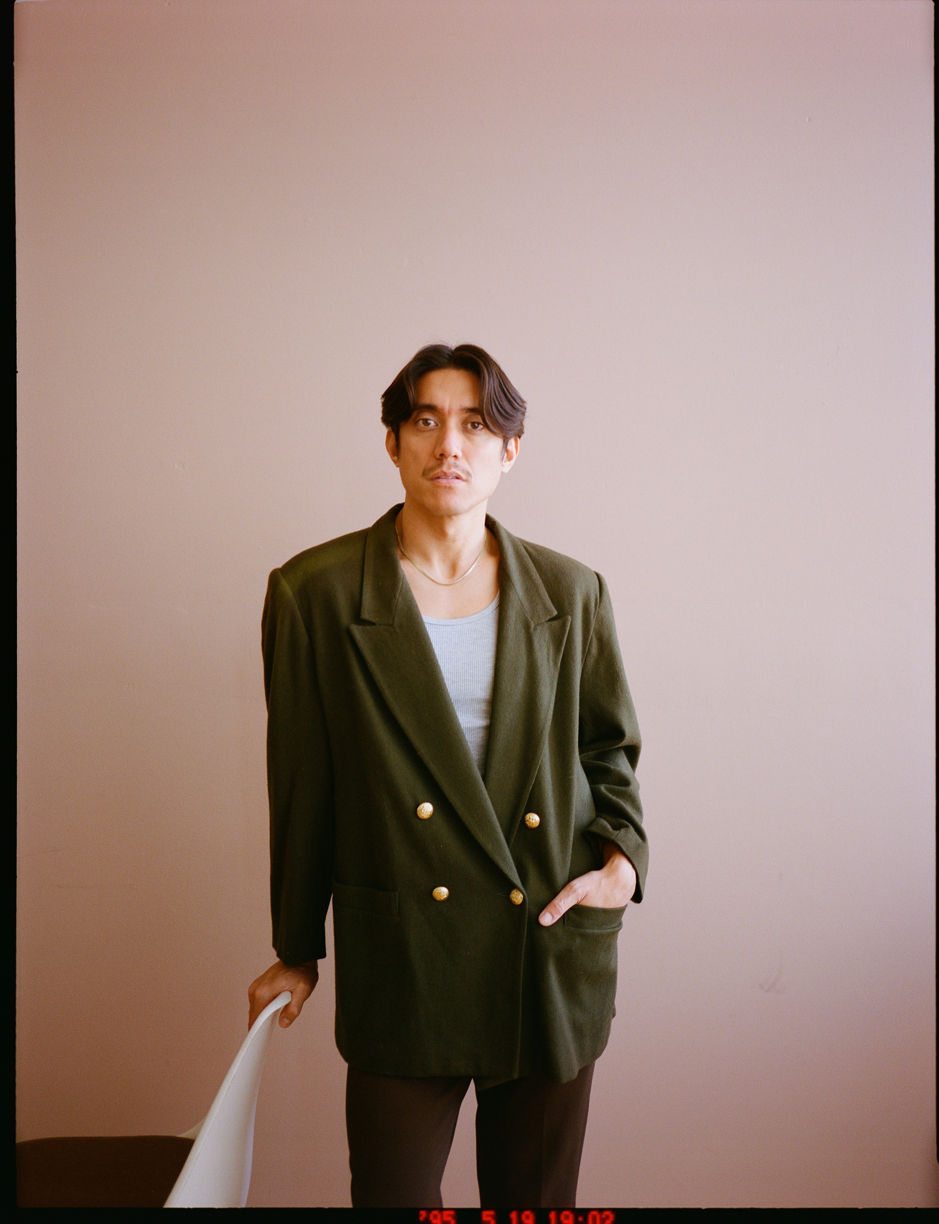 A person walks past buildings on a city street.