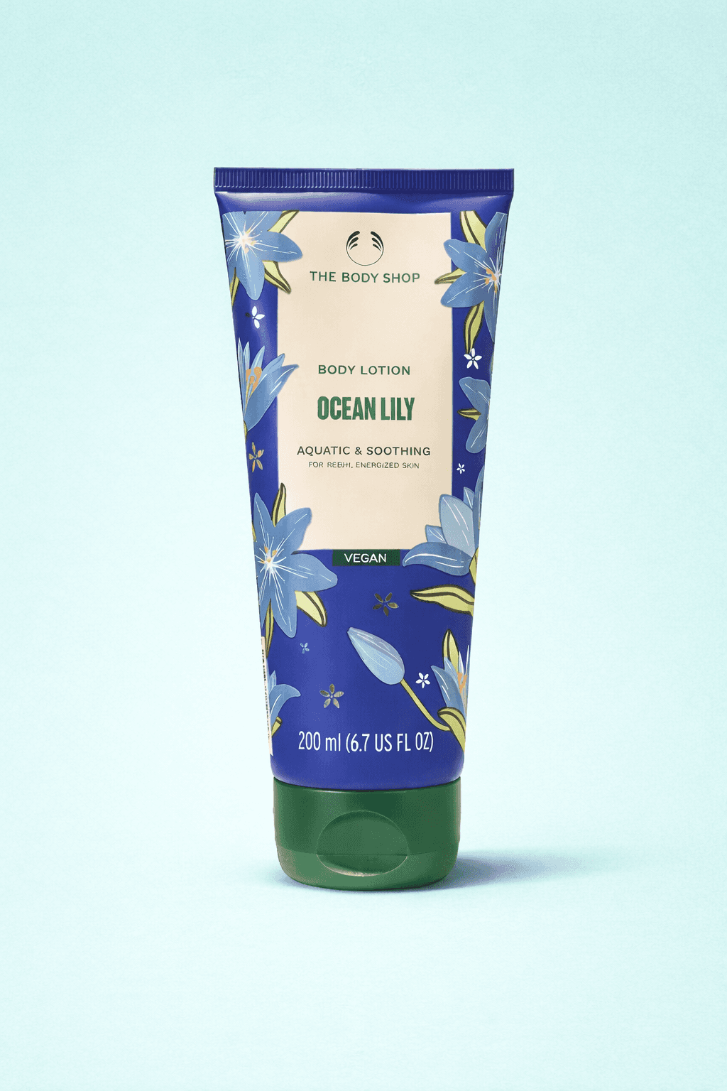 A smiling young man with crossed arms, wearing a plaid shirt and white t-shirt, poses against a dark background.