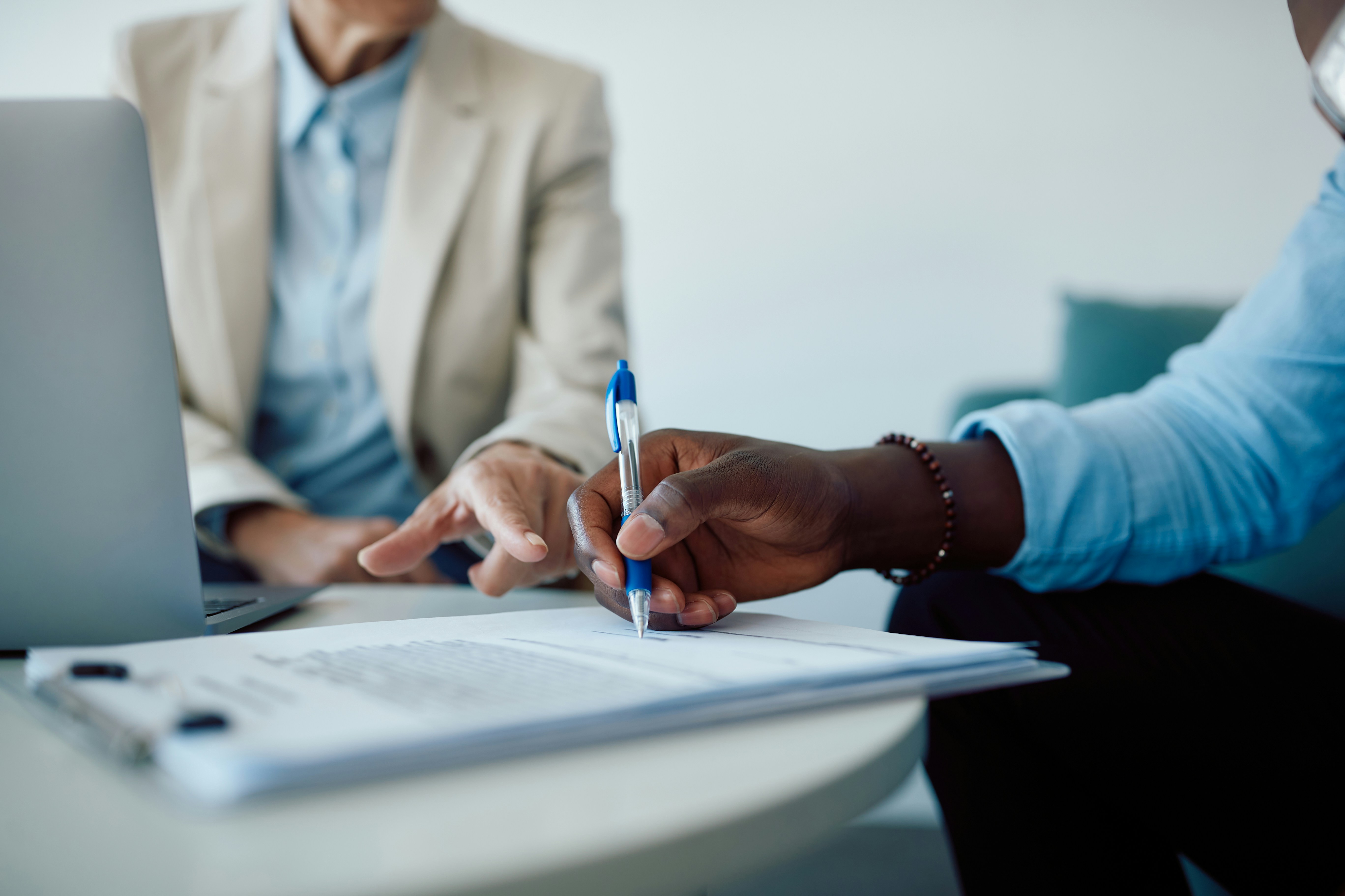 Man Holding Pen to Paper