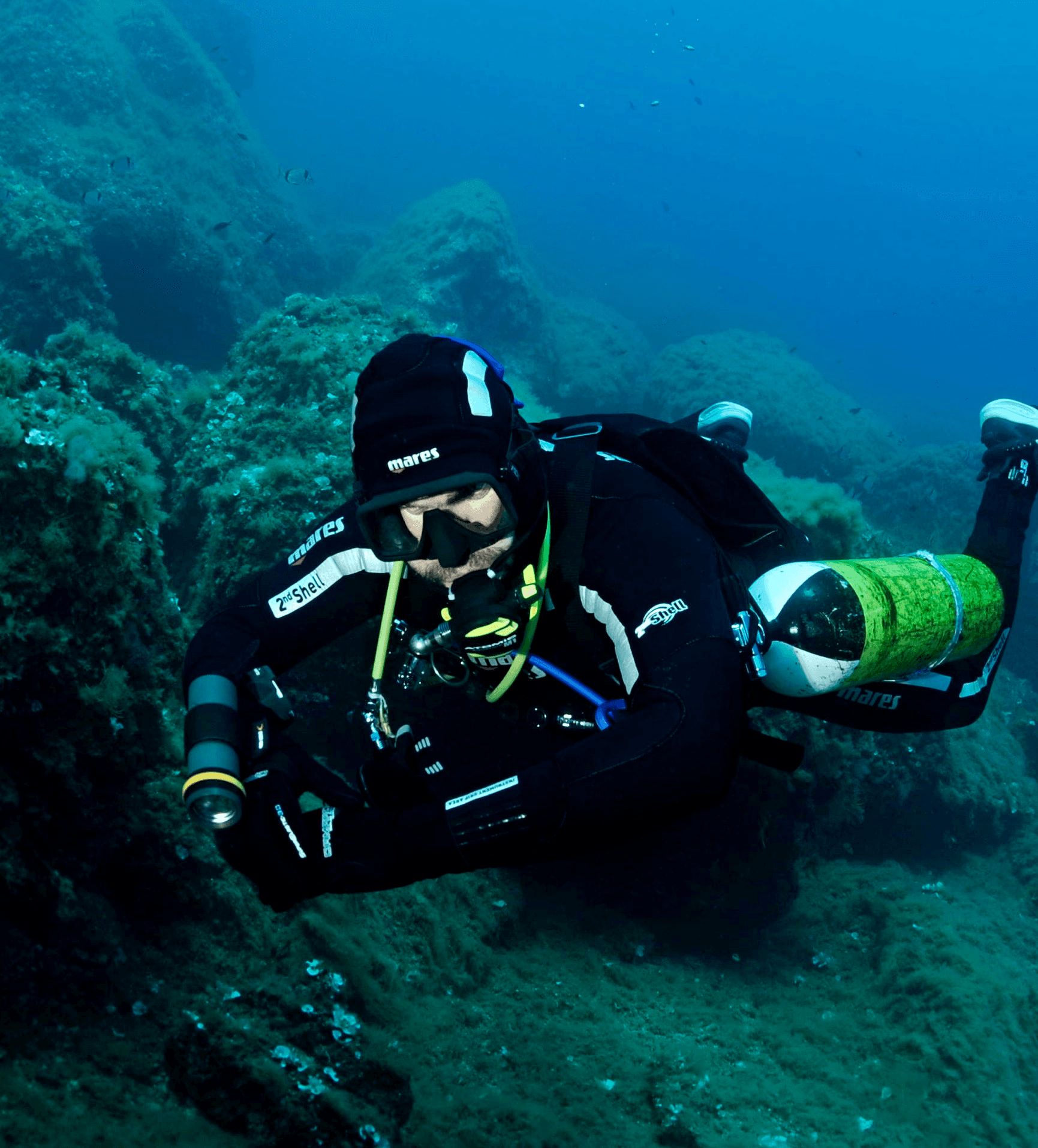 man in black shorts diving on water