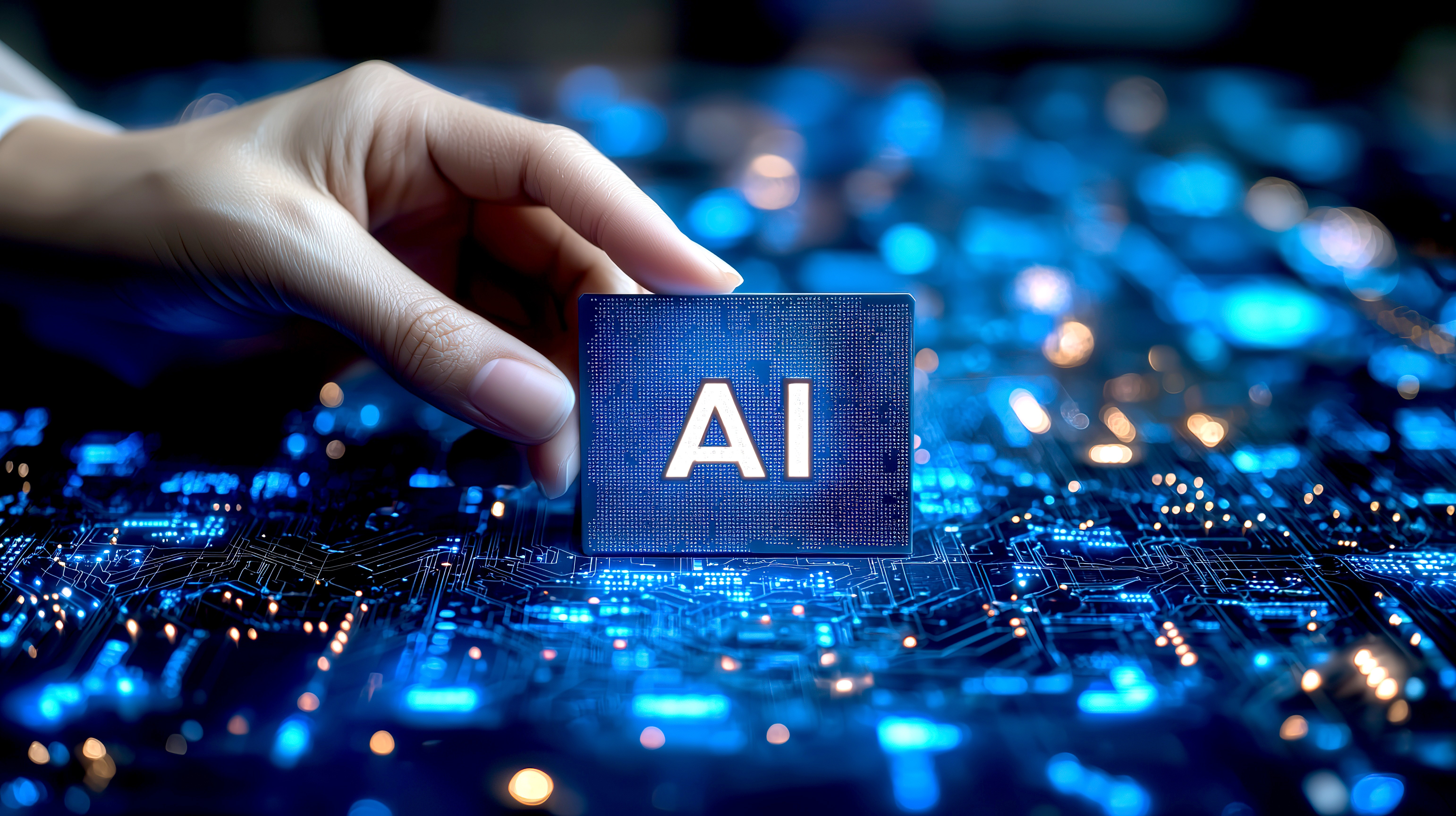 Hand holding AI chip over illuminated circuit board representing artificial intelligence in industrial cybersecurity